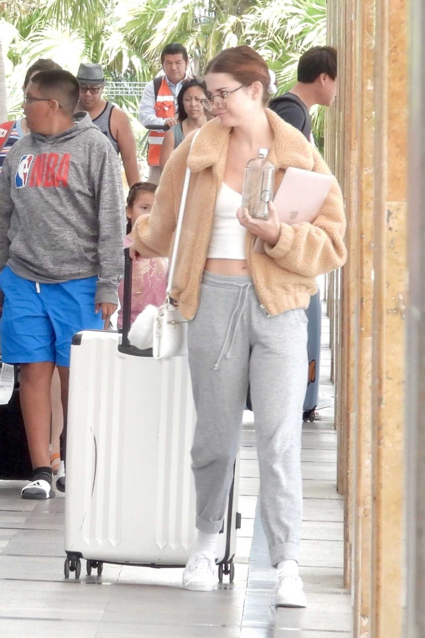 Maia Mitchell in a Gray Sweatpants Arrives at Cancun Airport in Tulum 06/26/2019