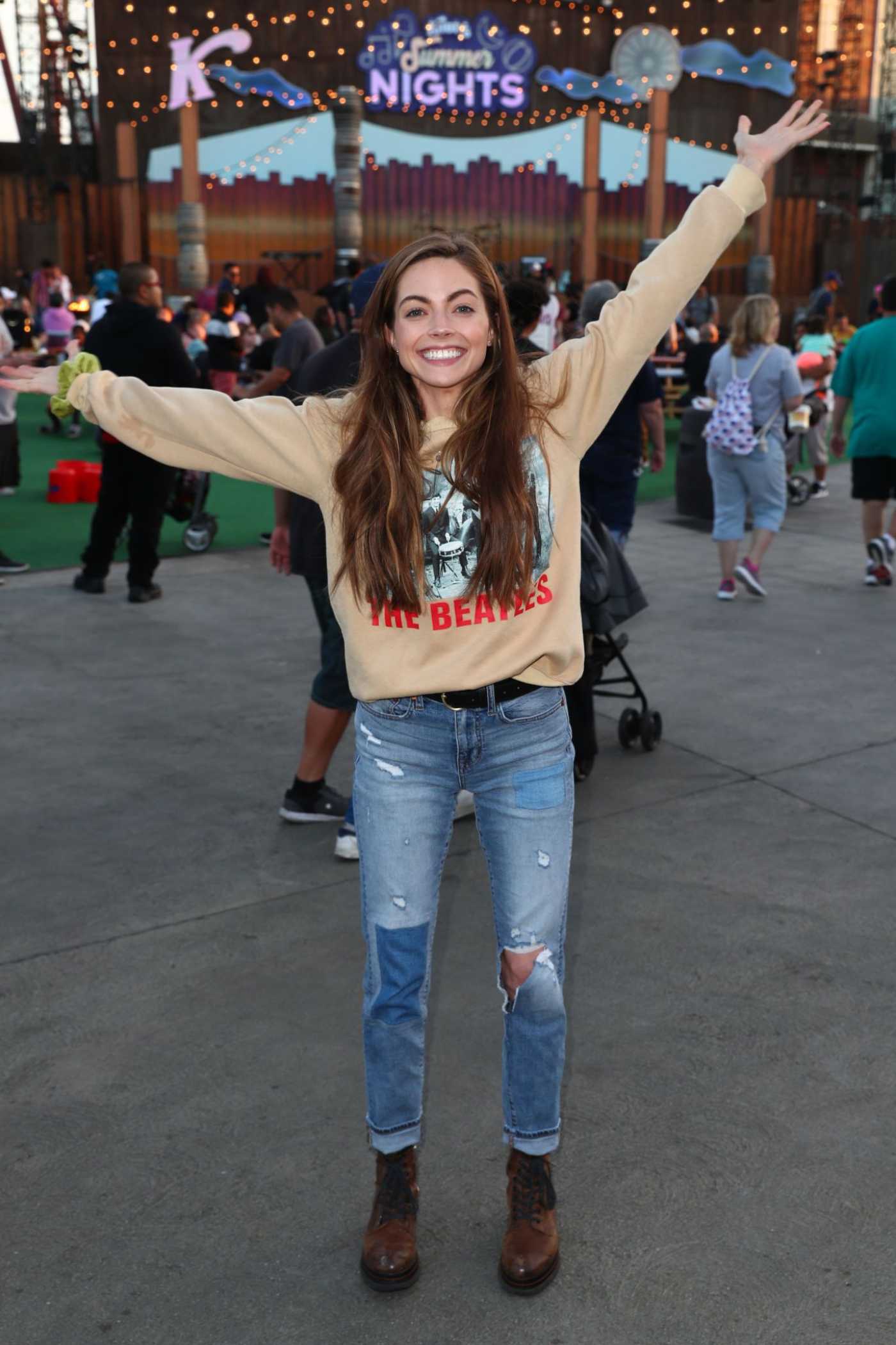 Caitlin Carver in a Blue Ripped Jeans Visits Knott's Summer Nights in Buena Park 07/06/2019