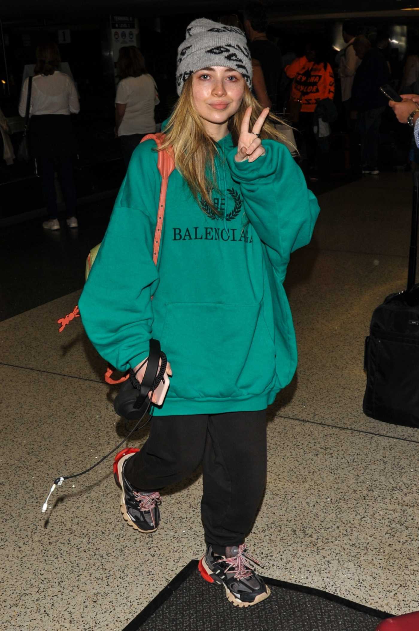 Sabrina Carpenter in a Green Hoody Arrives at LAX Airport in LA 06/29/2019