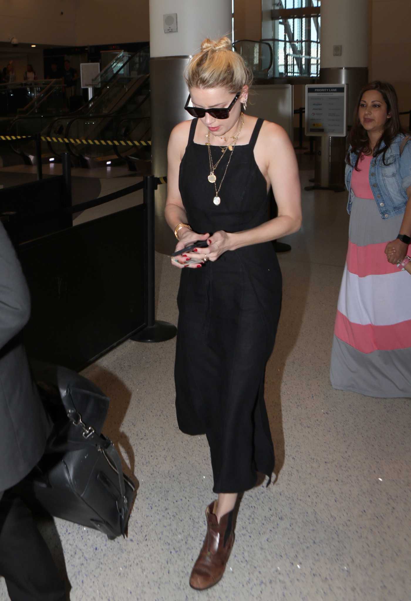 Amber Heard in a Black Dress Arrives at LAX Airport in Los Angeles 08/15/2019