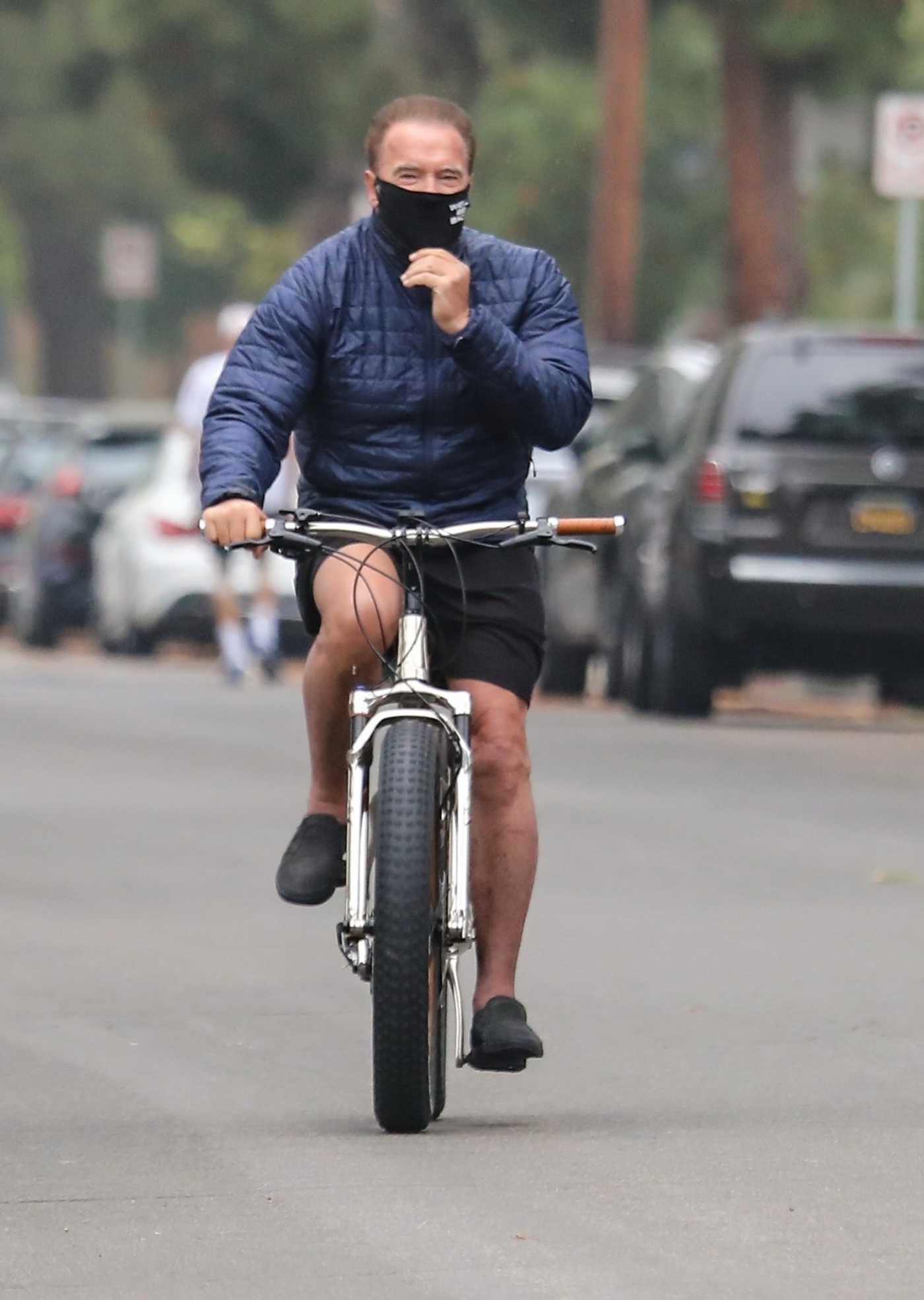 Arnold Schwarzenegger in a Black Face Mask Does a Bike Ride Out with His Daughter Christina Schwarzenegger in Santa Monica 04/30/2020