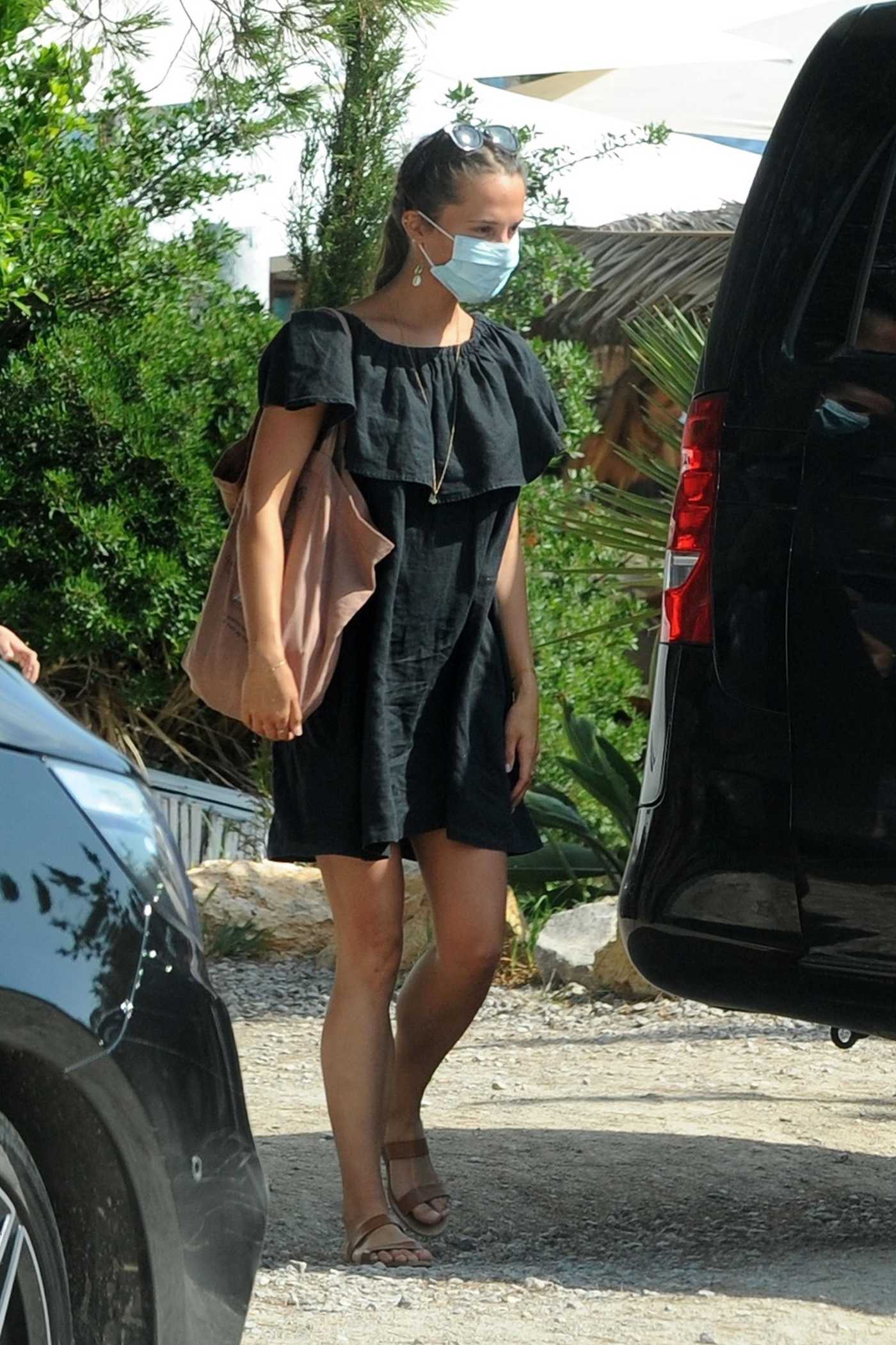 Alicia Vikander in a Black Dress Leaves the Es Xarcu Restaurant in Ibiza 07/20/2020