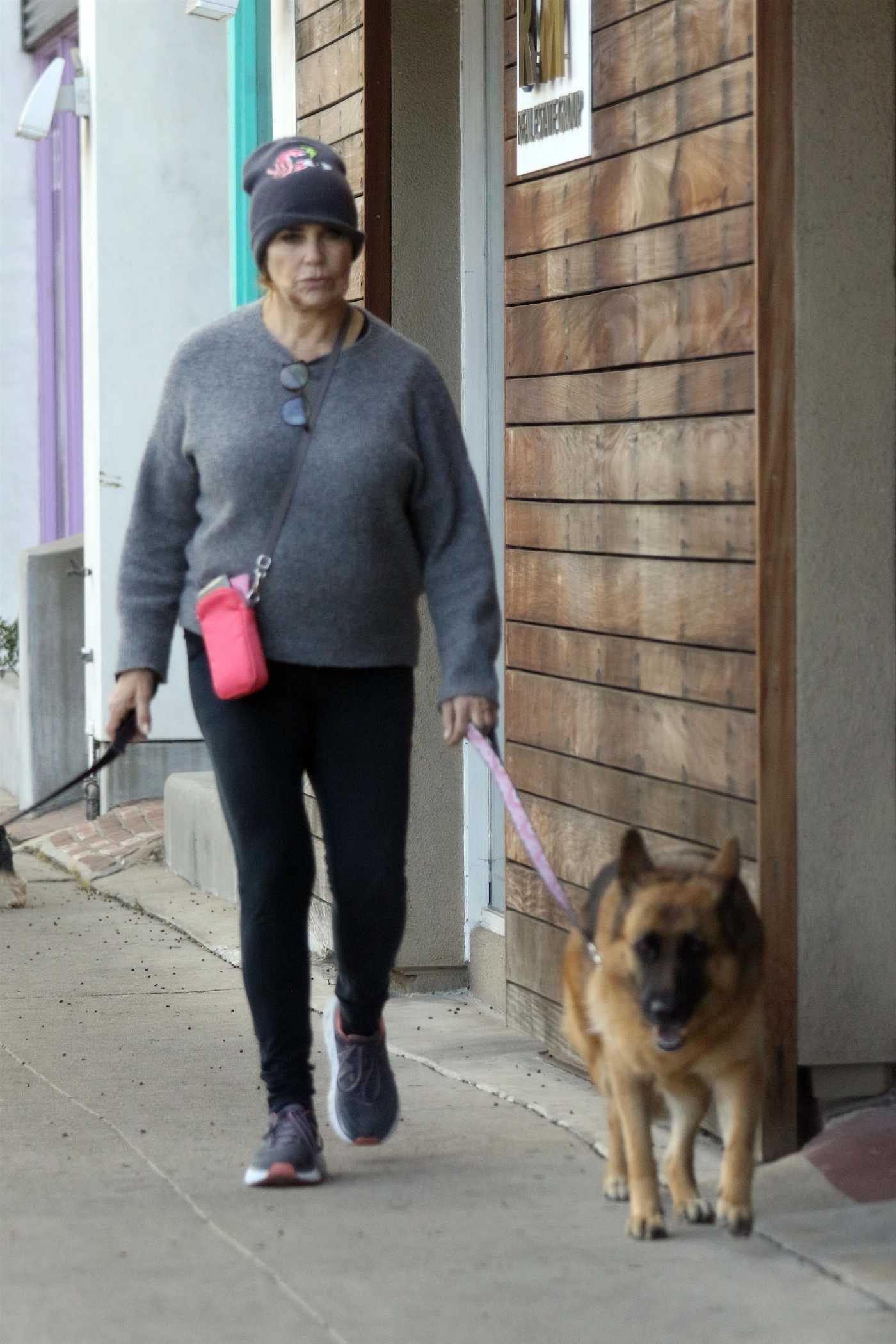 Catherine Bach in a Black Knit Hat Walks Her Dogs in Los Angeles 12/13/2020