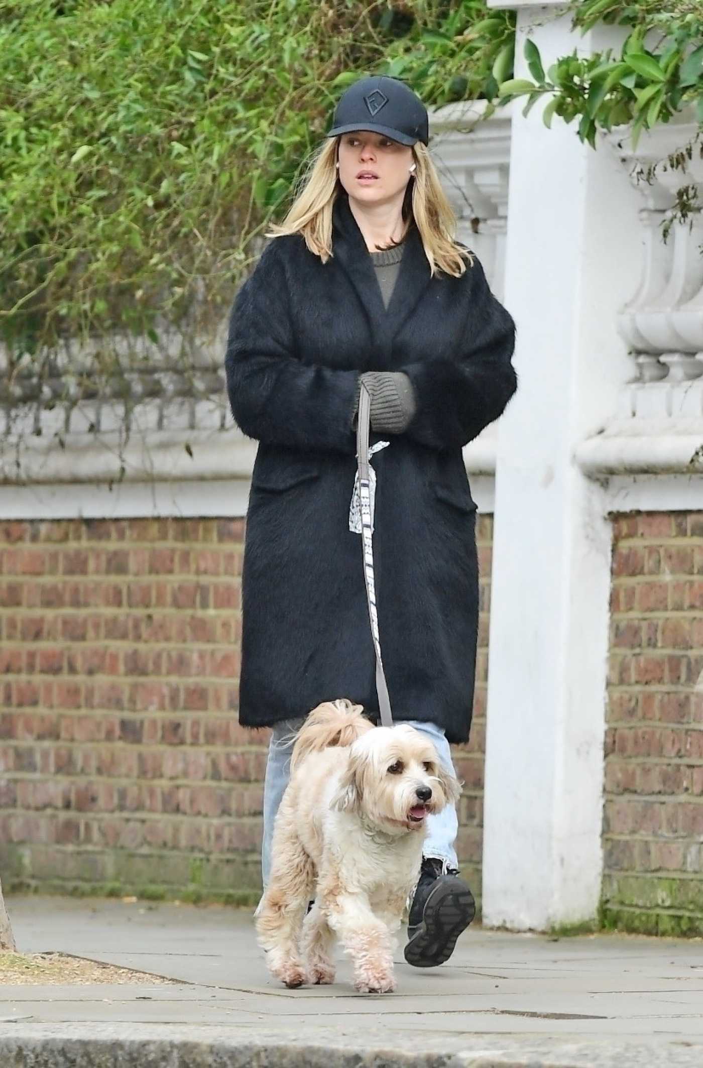 Alice Eve in a Black Coat Walks Her Dog During the COVID-19 Lockdown in London 02/25/2021