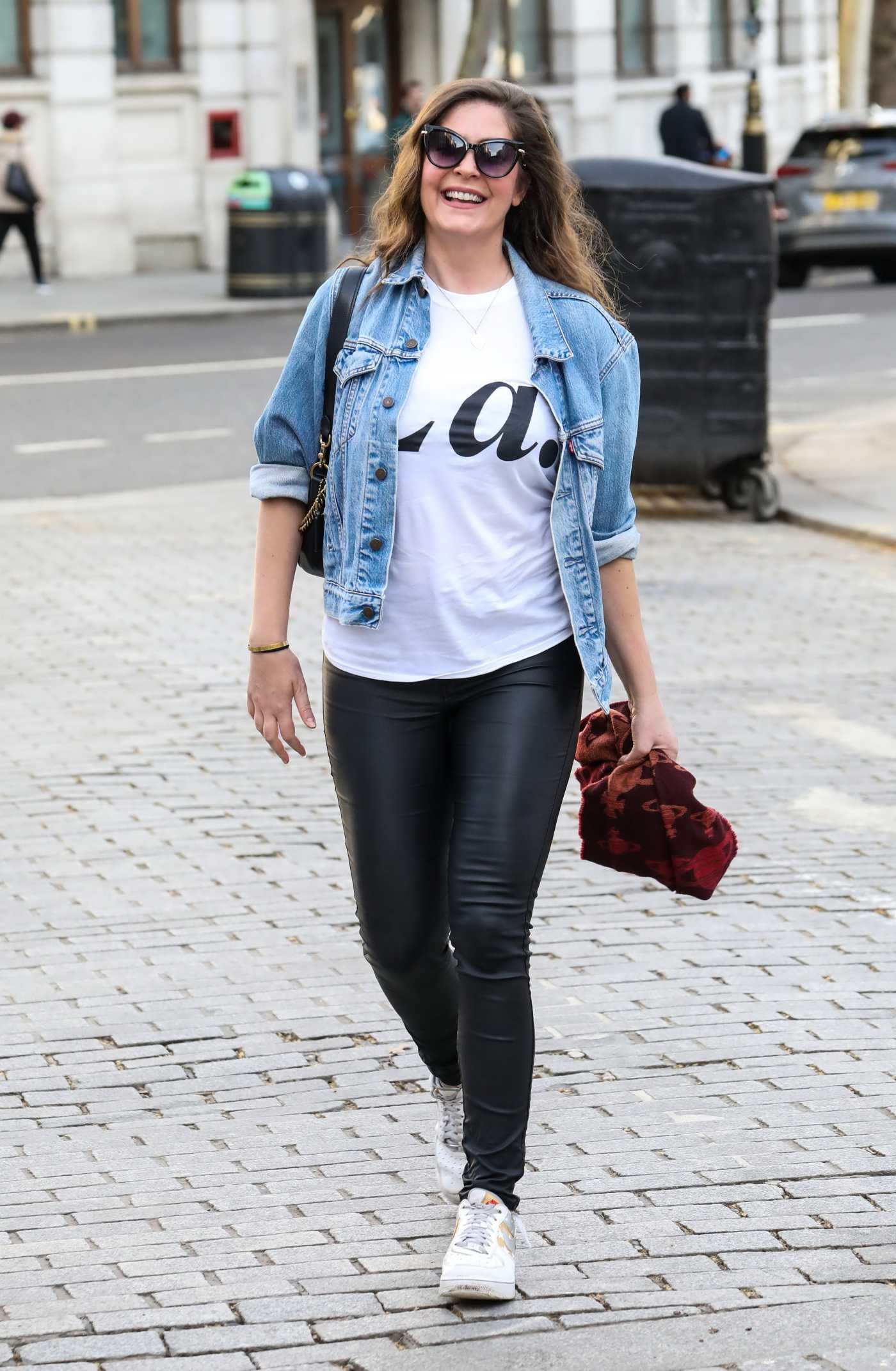 Lucy Horobin in a Blue Denim Jacket Arrives at the Global Radio Studios in London 02/23/2021