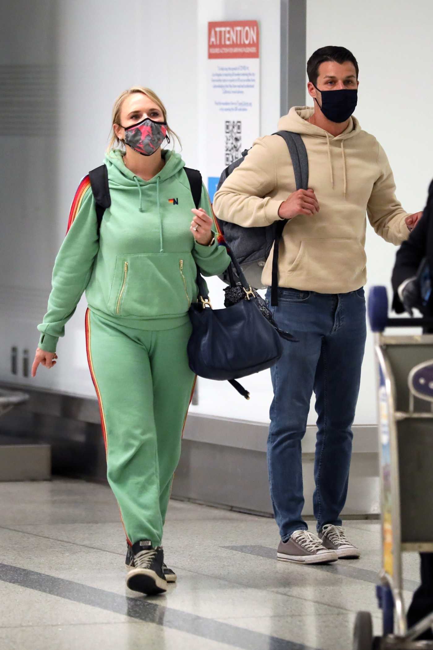Miranda Lambert in a Green Sweatsuit Arrives at LAX Airport Out with Brendan Mcloughlin in Los Angeles 03/06/2021