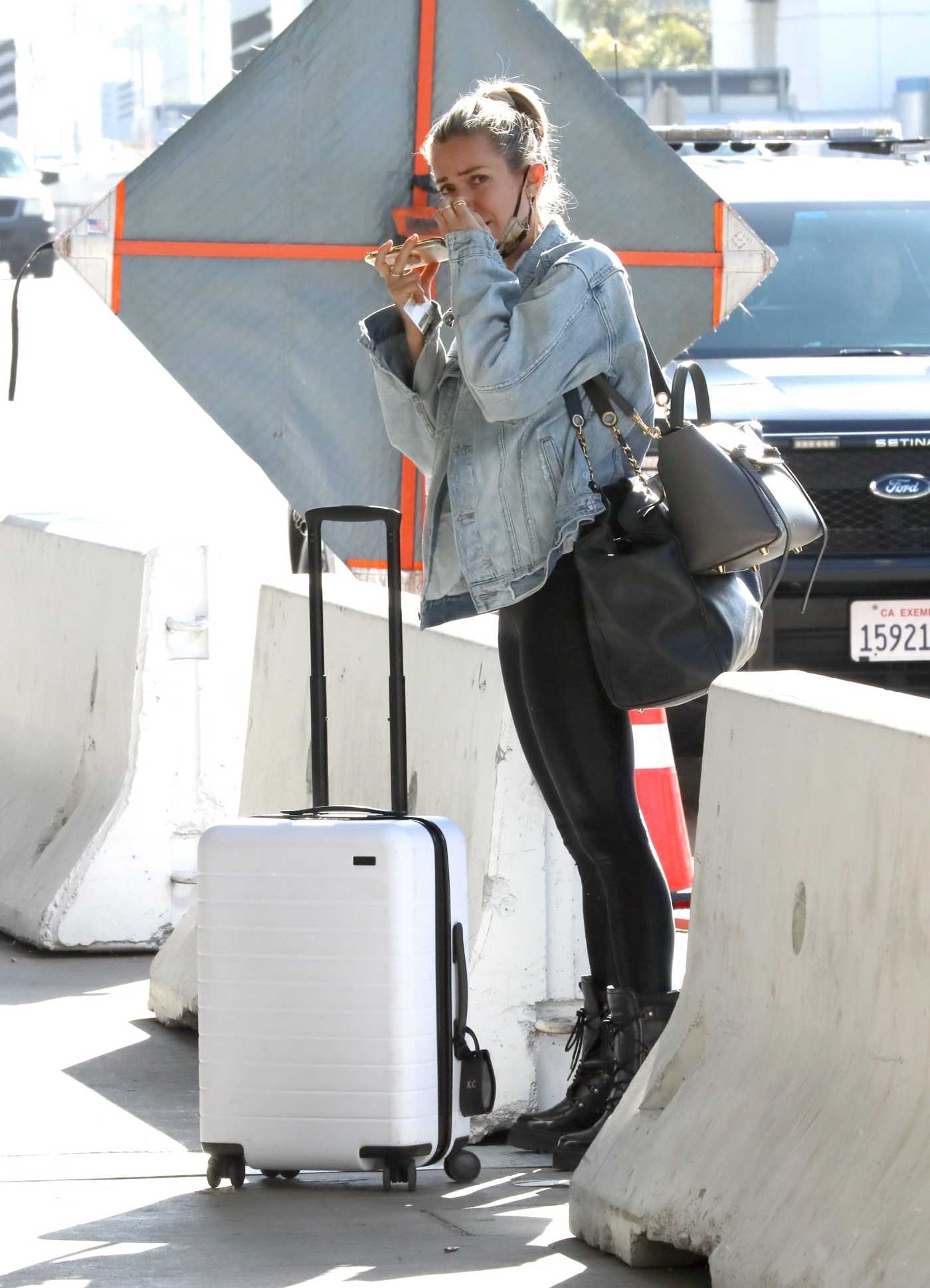 Kristin Cavallari in a Blue Denim Jacket Arrives at LAX Airport in Los Angeles 03/31/2021