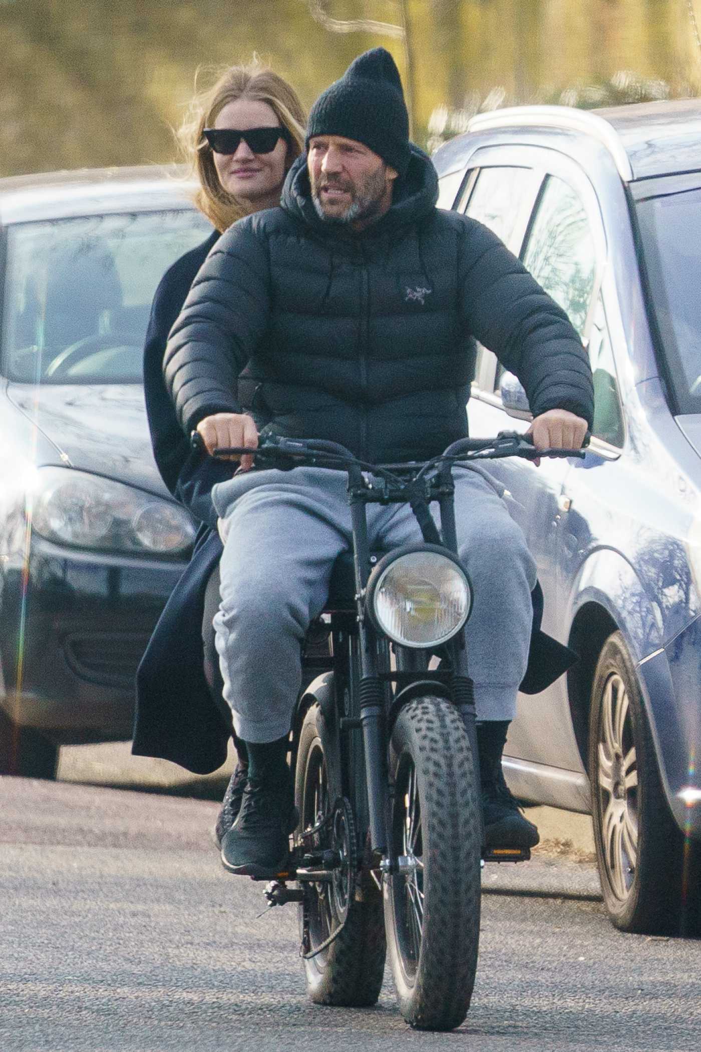 Rosie Huntington-Whiteley in a Black Coat Does a Bike Ride with Jason Statham in London 03/24/2021