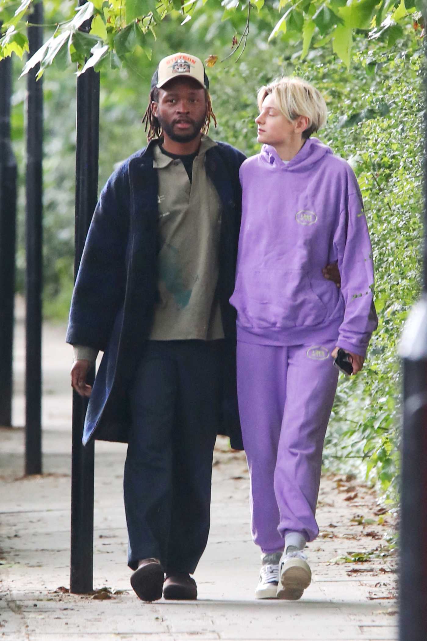 Emma Corrin in a Purple Sweatsuit Holds Hands with Art Director Ibby Njoya on a Stroll in London 07/12/2021