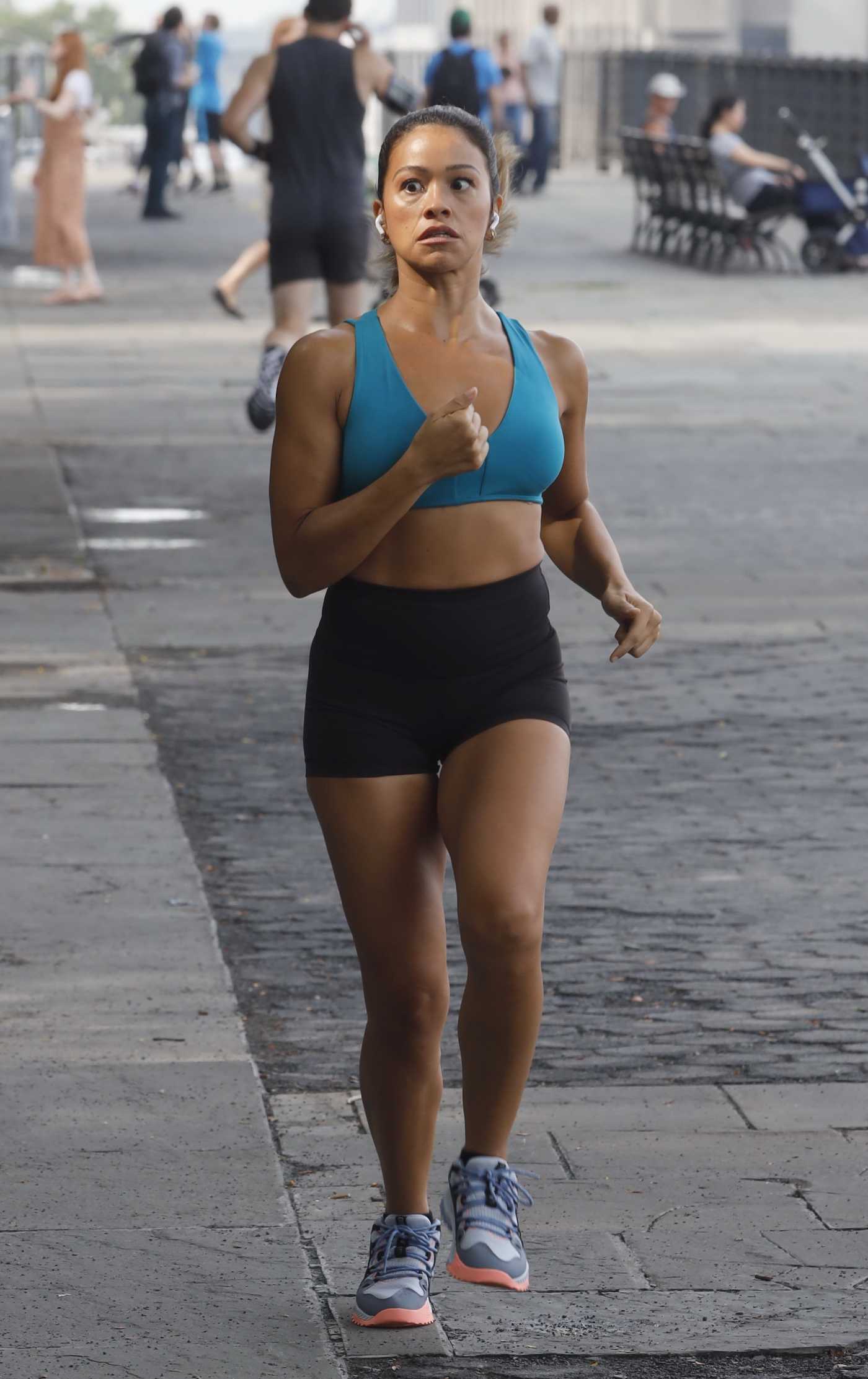 Gina Rodriguez in a Blue Sports Bra Films a Jogging Scene for Players in New York 07/27/2021