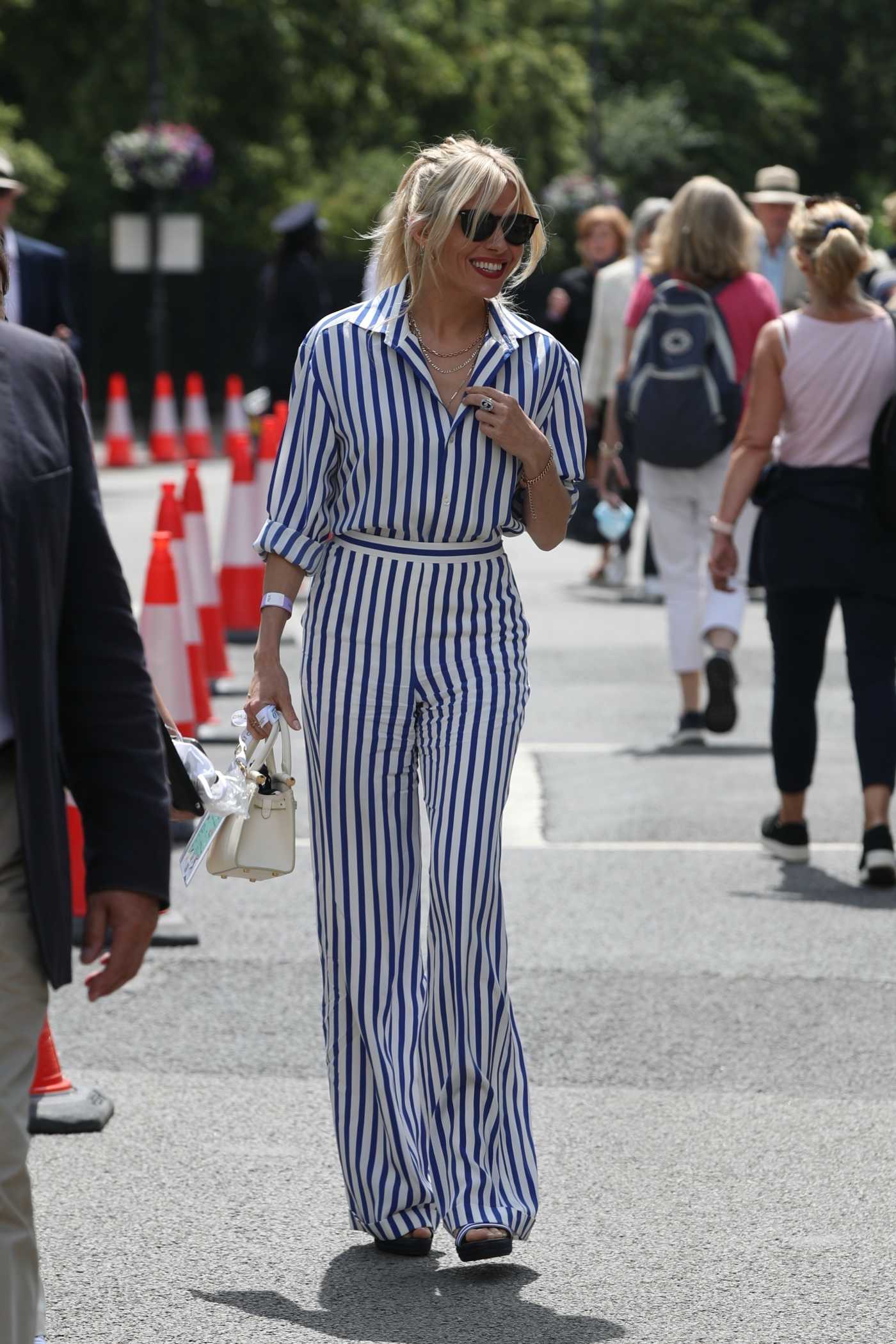 Sienna Miller in a Striped Jumpsuit Arrives at Wimbledon in London 07/05/2021