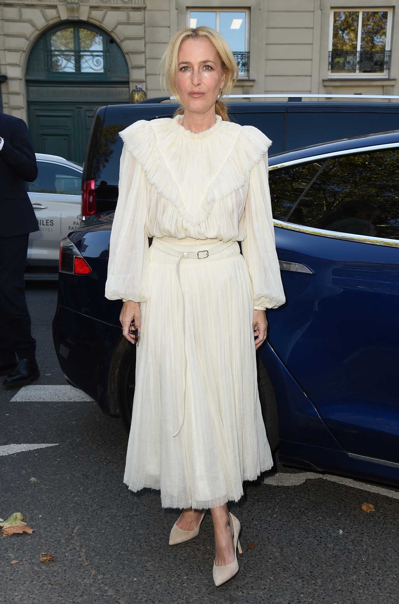 Gillian Anderson in a White Dress Arrives at Chloe Fashion Show During 2021 Paris Fashion Week in Paris 09/30/2021