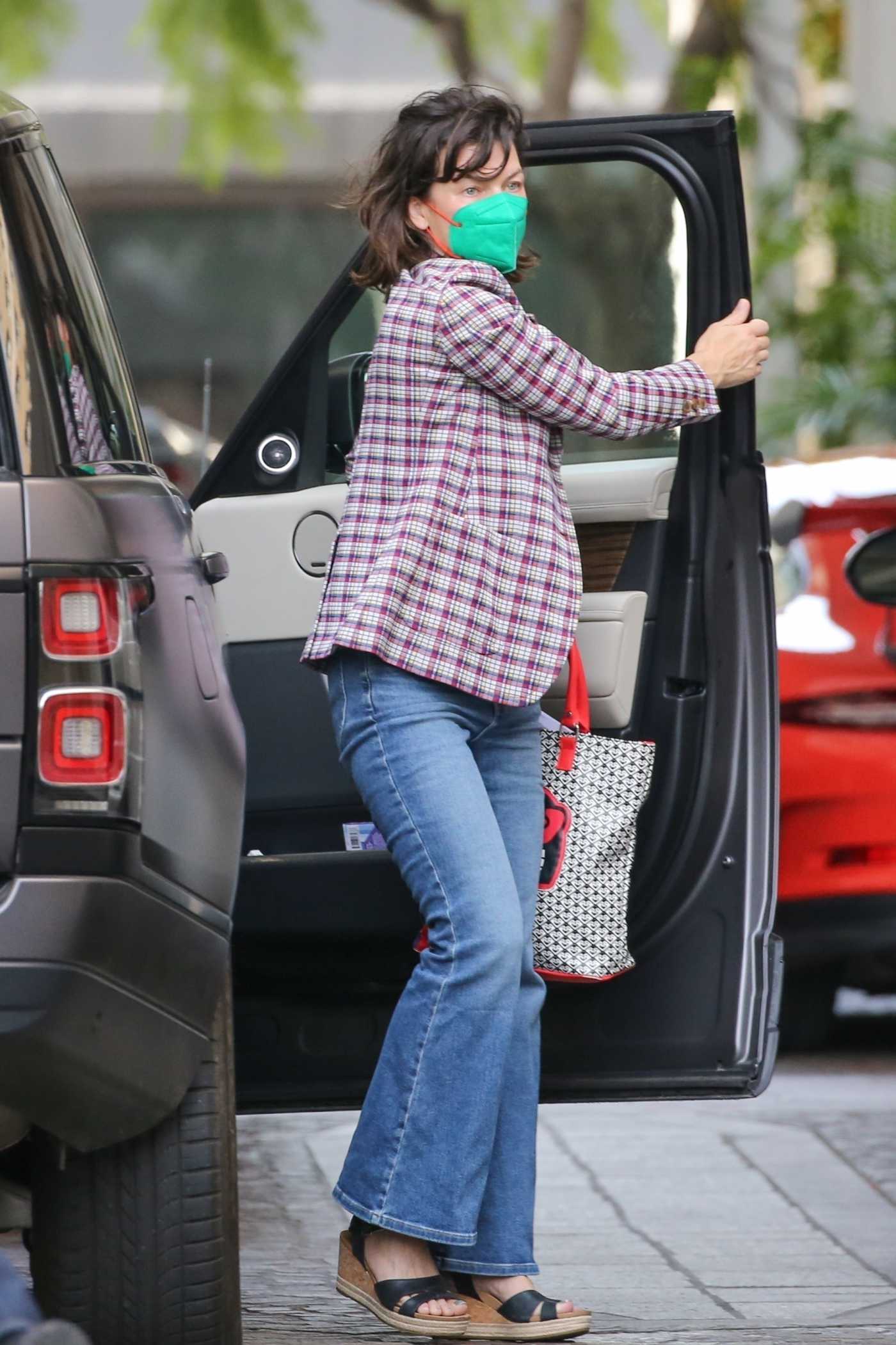 Milla Jovovich in a Green Protective Mask Arrives Lunch at Beverly Wilshire Hotel in Beverly Hills 10/22/2021