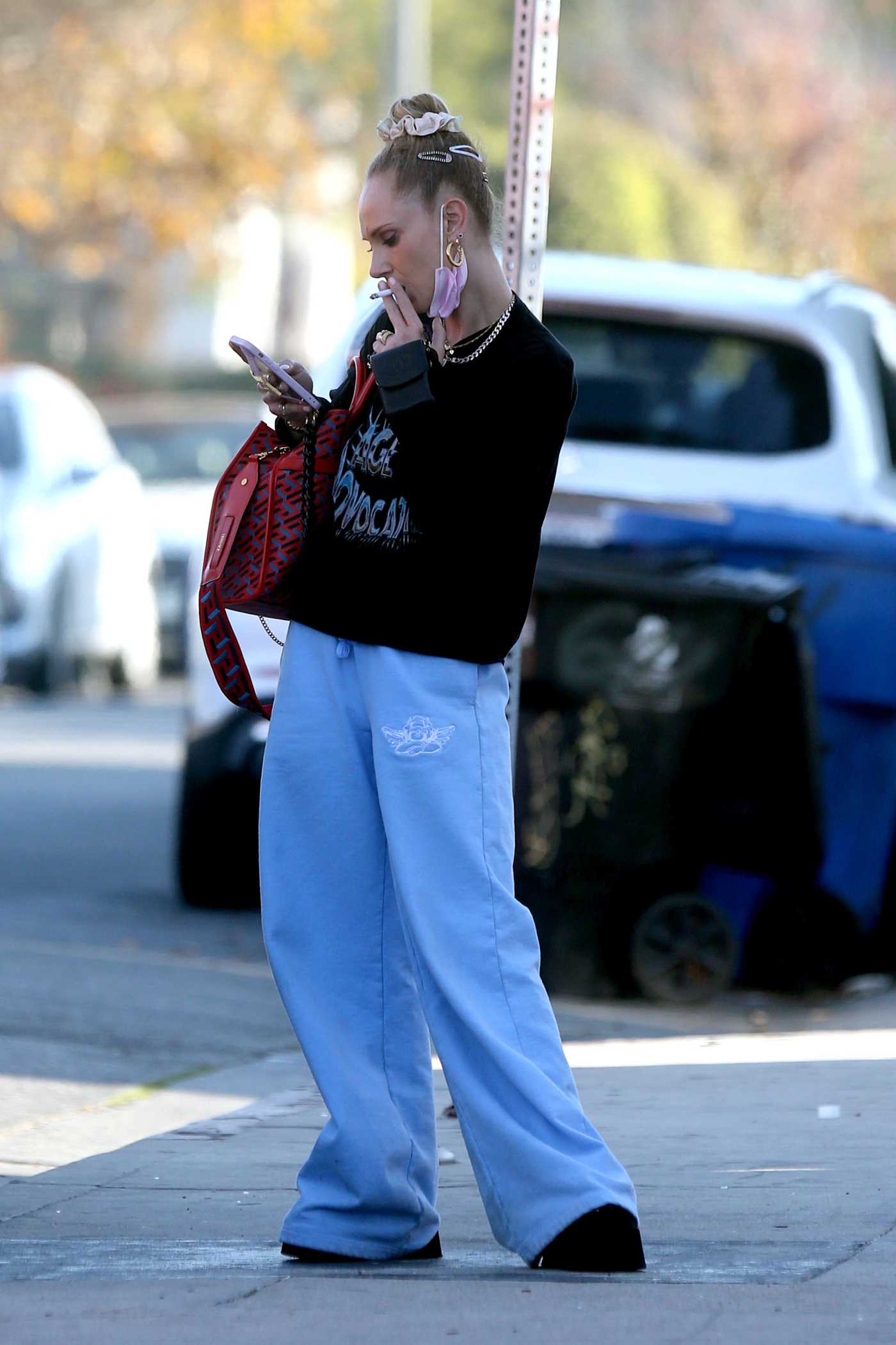 Juno Temple in a Blue Sweatpants Pausing for a Smoke on Melrose in Los Angeles 11/04/2021