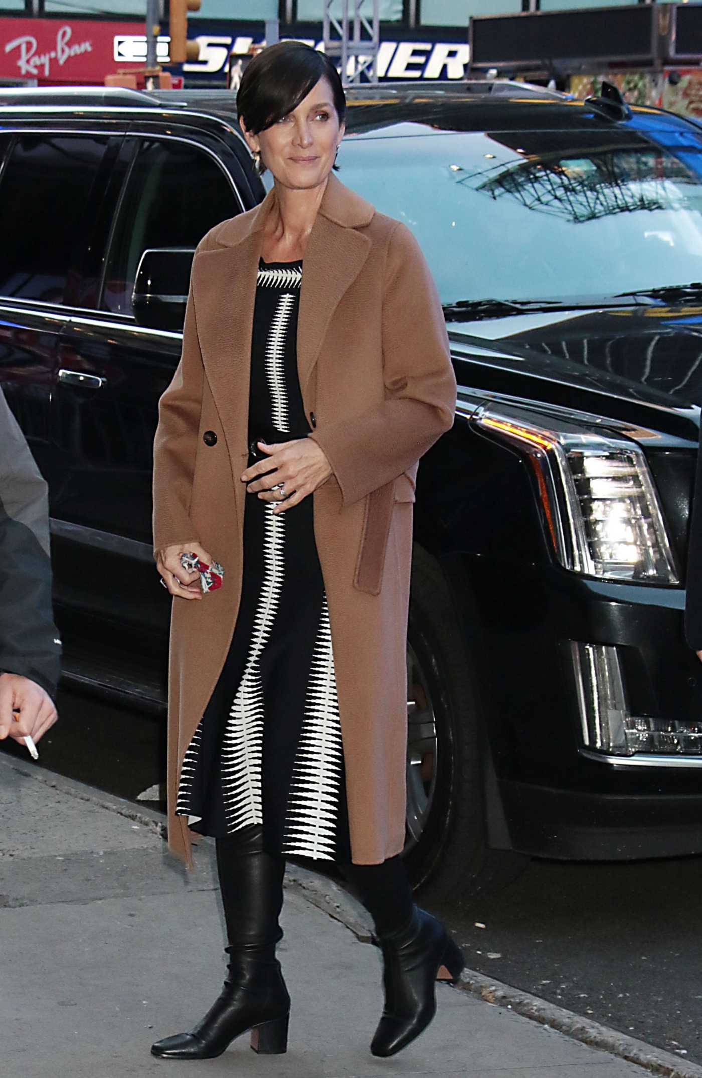 Carrie-Anne Moss in a Tan Coat Promotes The Matrix Resurrections at Good Morning America in New York 12/14/2021
