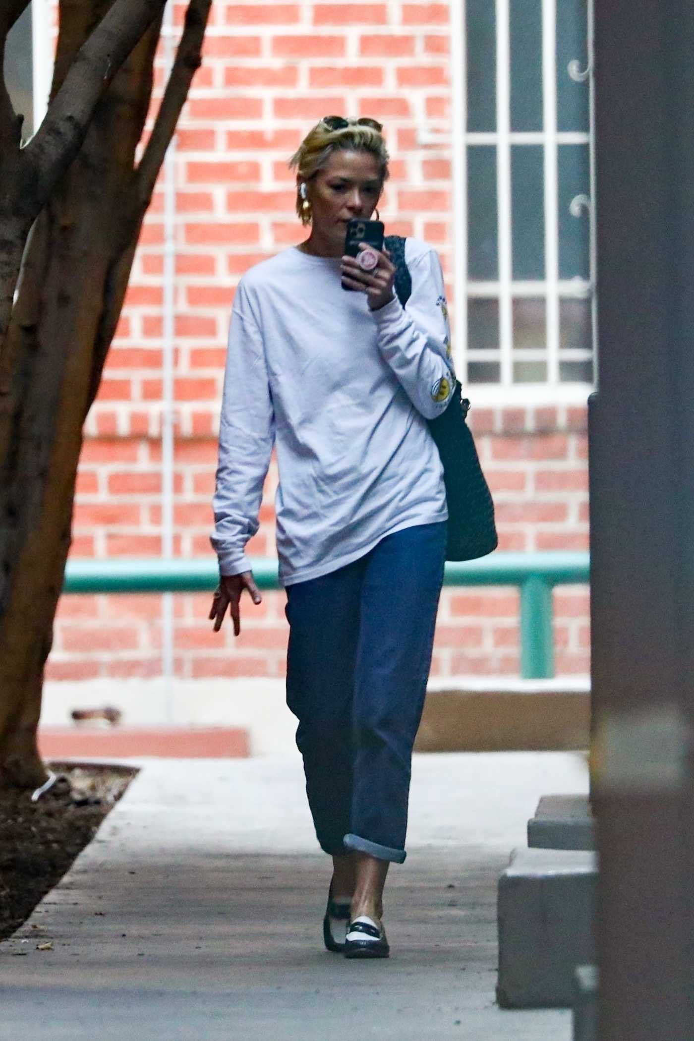 Jaime King in a White Long Sleeves T-Shirt Takes a Phone Call as She Walks Through Beverly Hills 11/30/2021