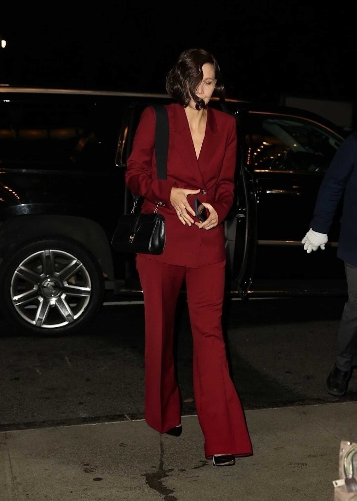 Maggie Gyllenhaal in a Maroon Pantsuit Was Seen Out in New York 12/15/2021