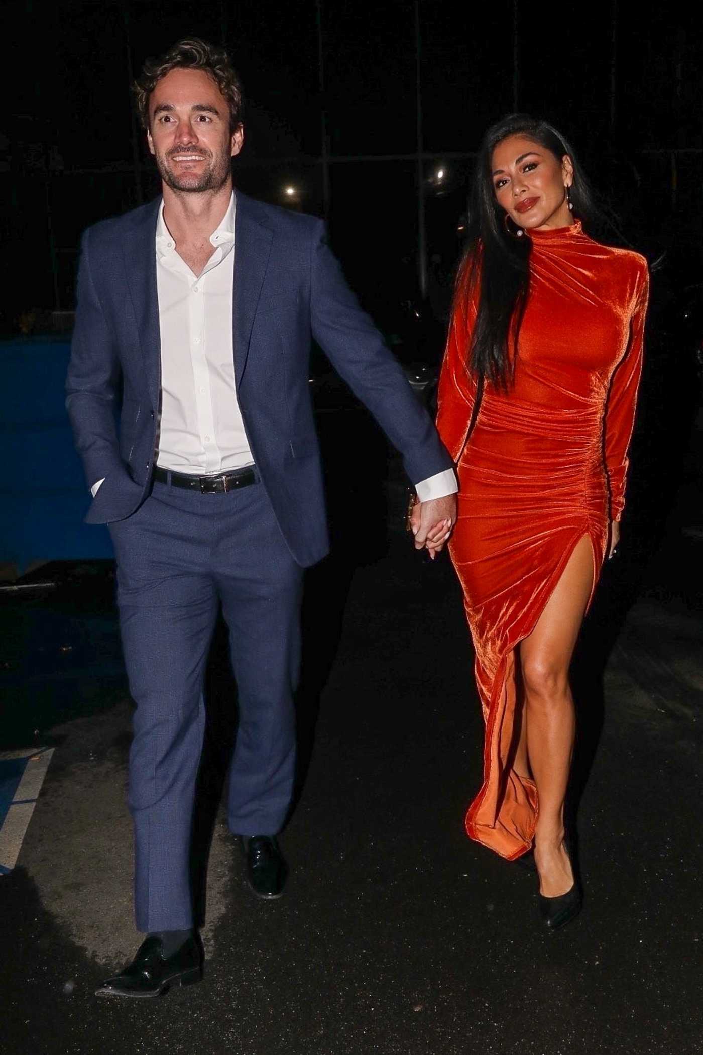 Nicole Scherzinger in a Red Dress Enjoys a Dinner Date with Thom Evans at Tatel in Beverly Hills 01/15/2022
