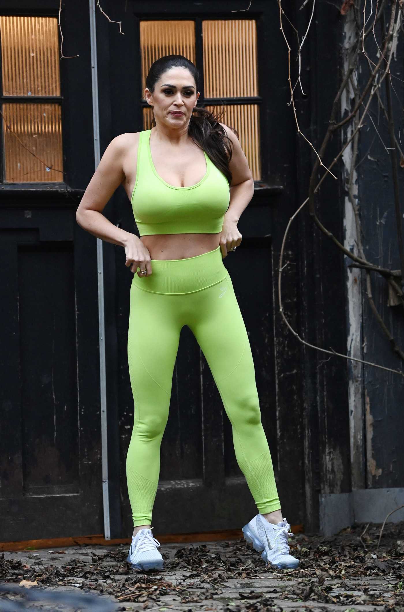 Casey Batchelor in a Neon Green Workout Ensemble Filming Her Yoga Blitz App in East London 02/07/2022