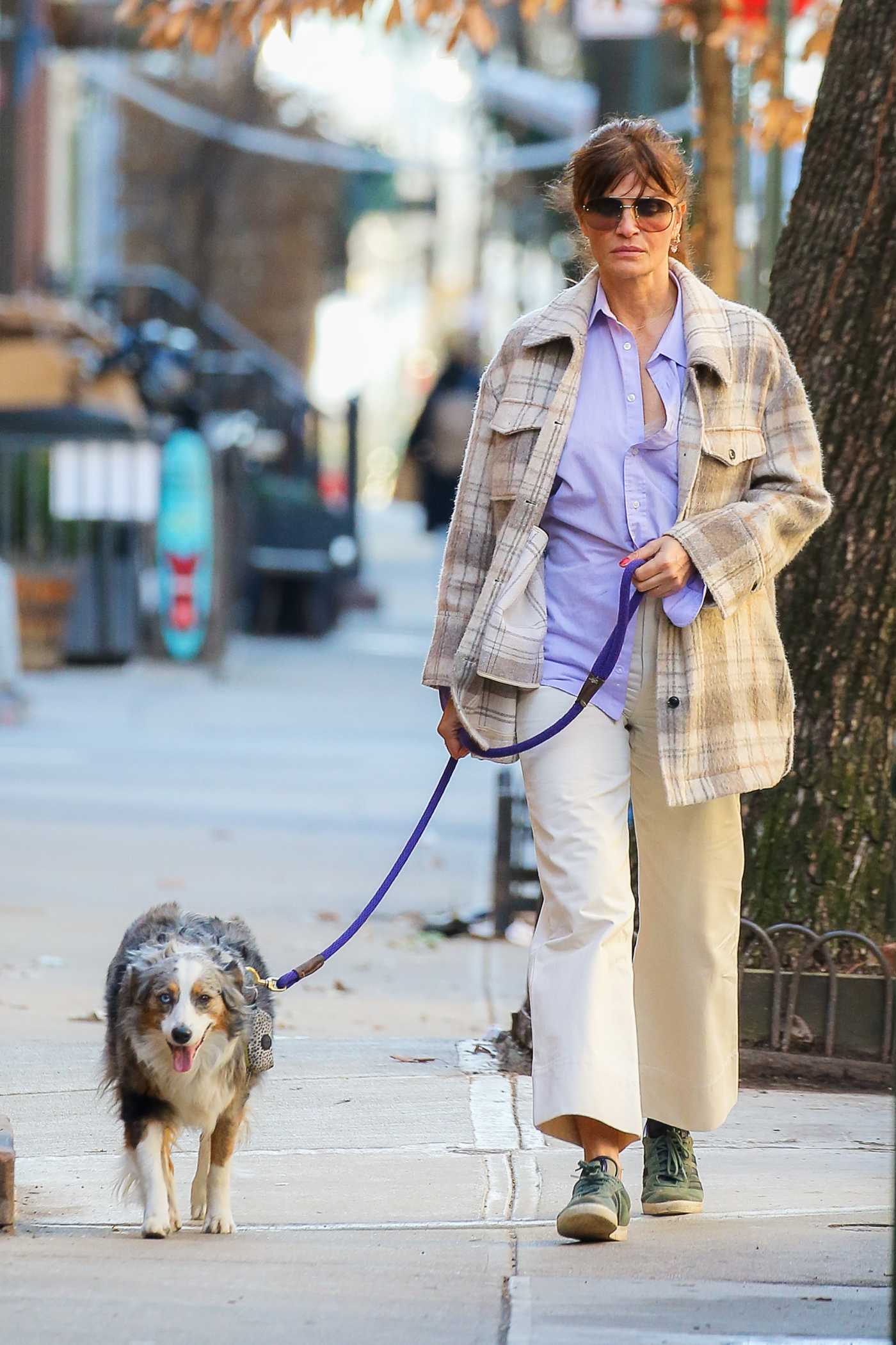 Helena Christensen in a Plaid Shirt Walks Her Dog in New York 02/11/2022