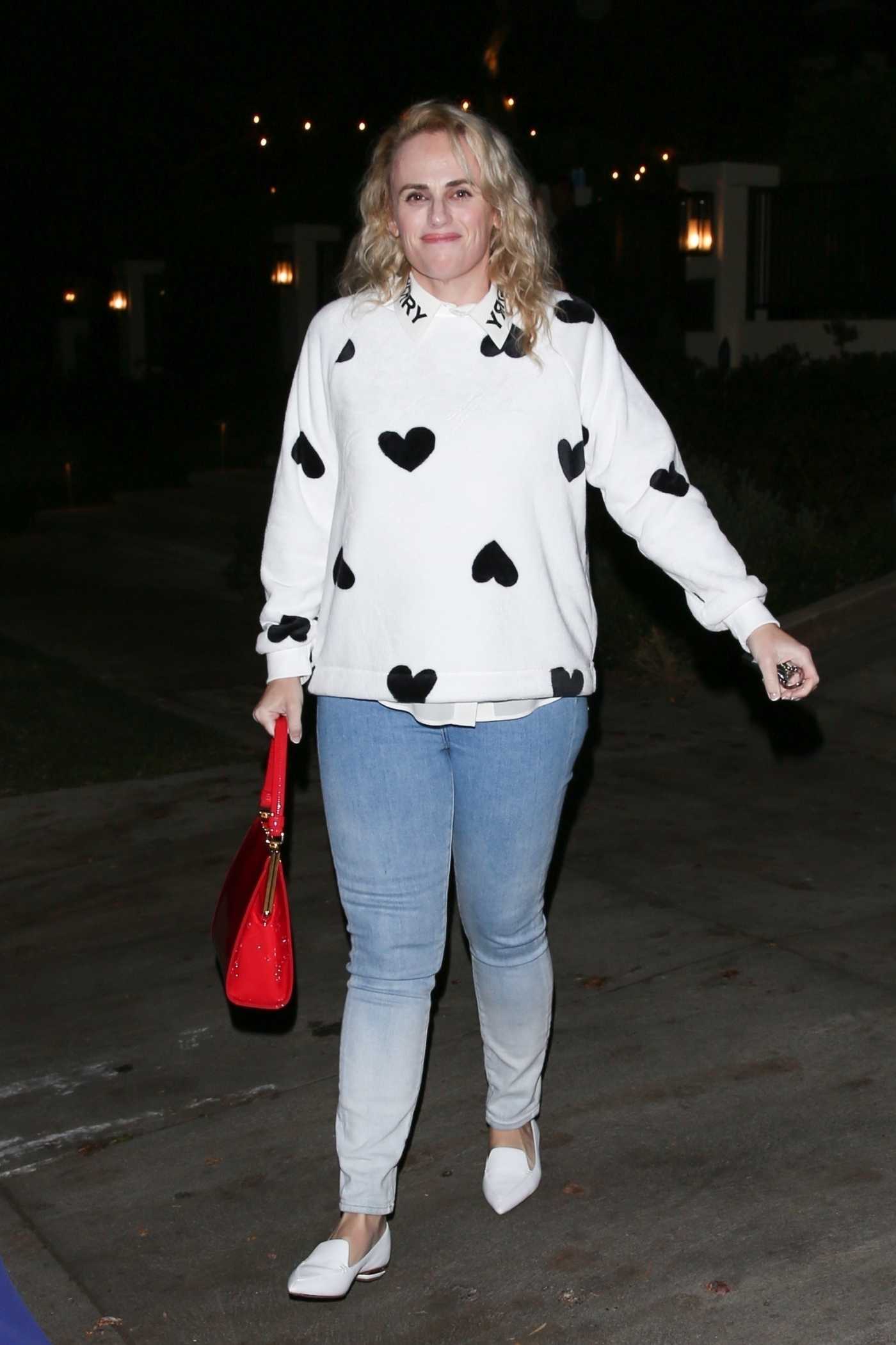 Rebel Wilson in a White Sweater Leaves the Casamigos Super Bowl LVI Pre Party in Beverly Hills 02/13/2022