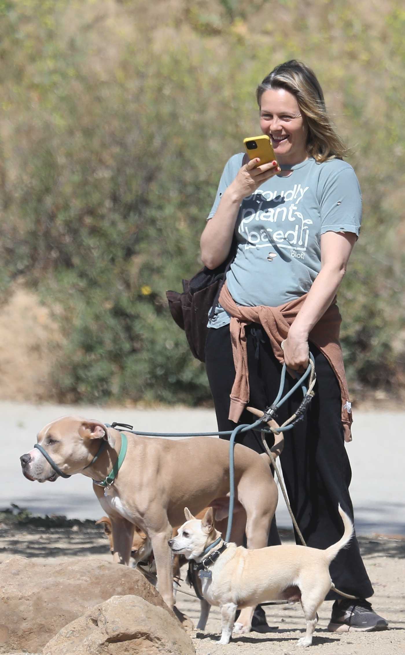 Alicia Silverstone in a Black Sweatpants Walks Her Dogs in Hollywood 04/22/2022