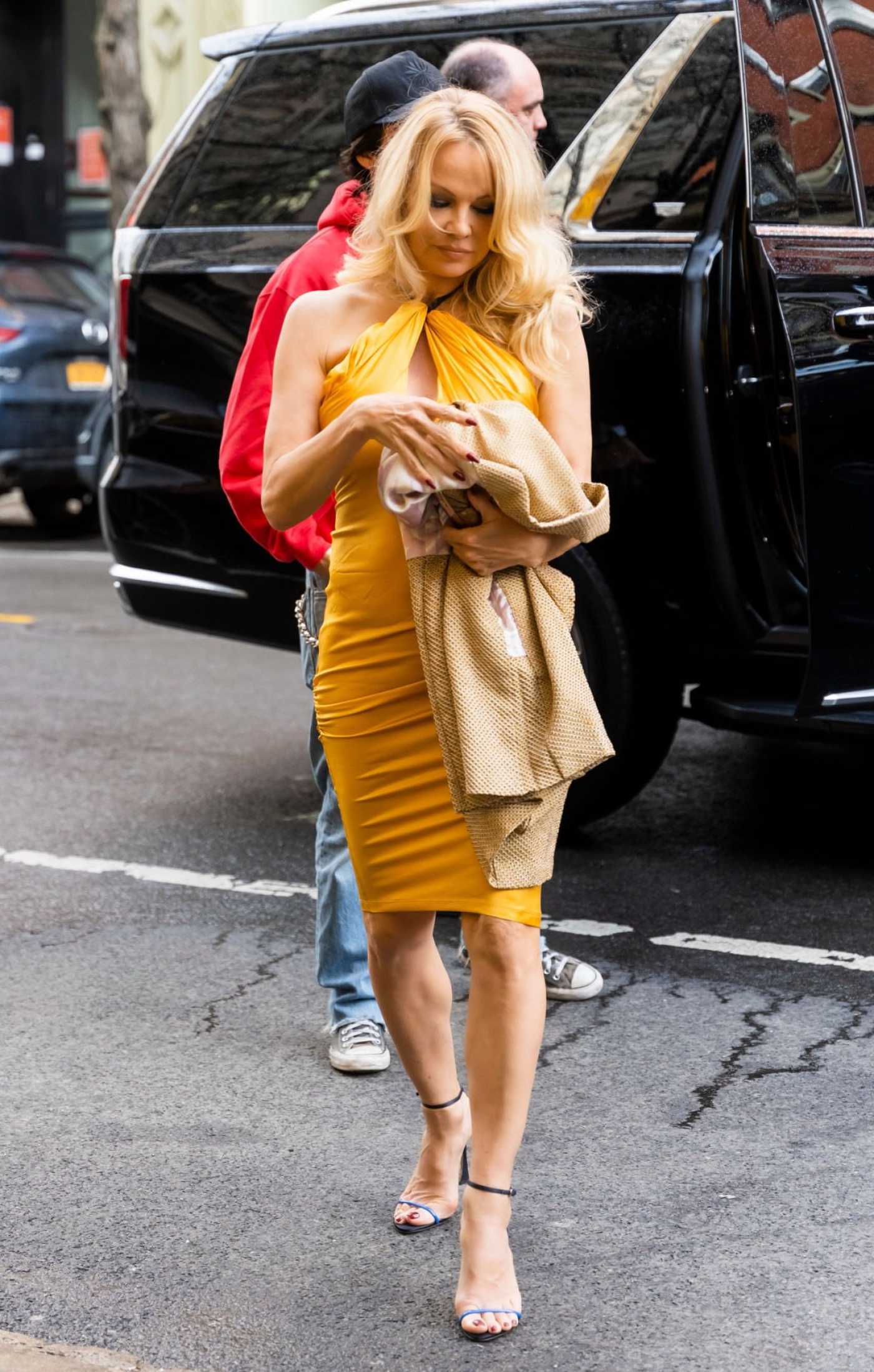 Pamela Anderson in a Yellow Dress Was Seen Out in SoHo in New York City 04/09/2022