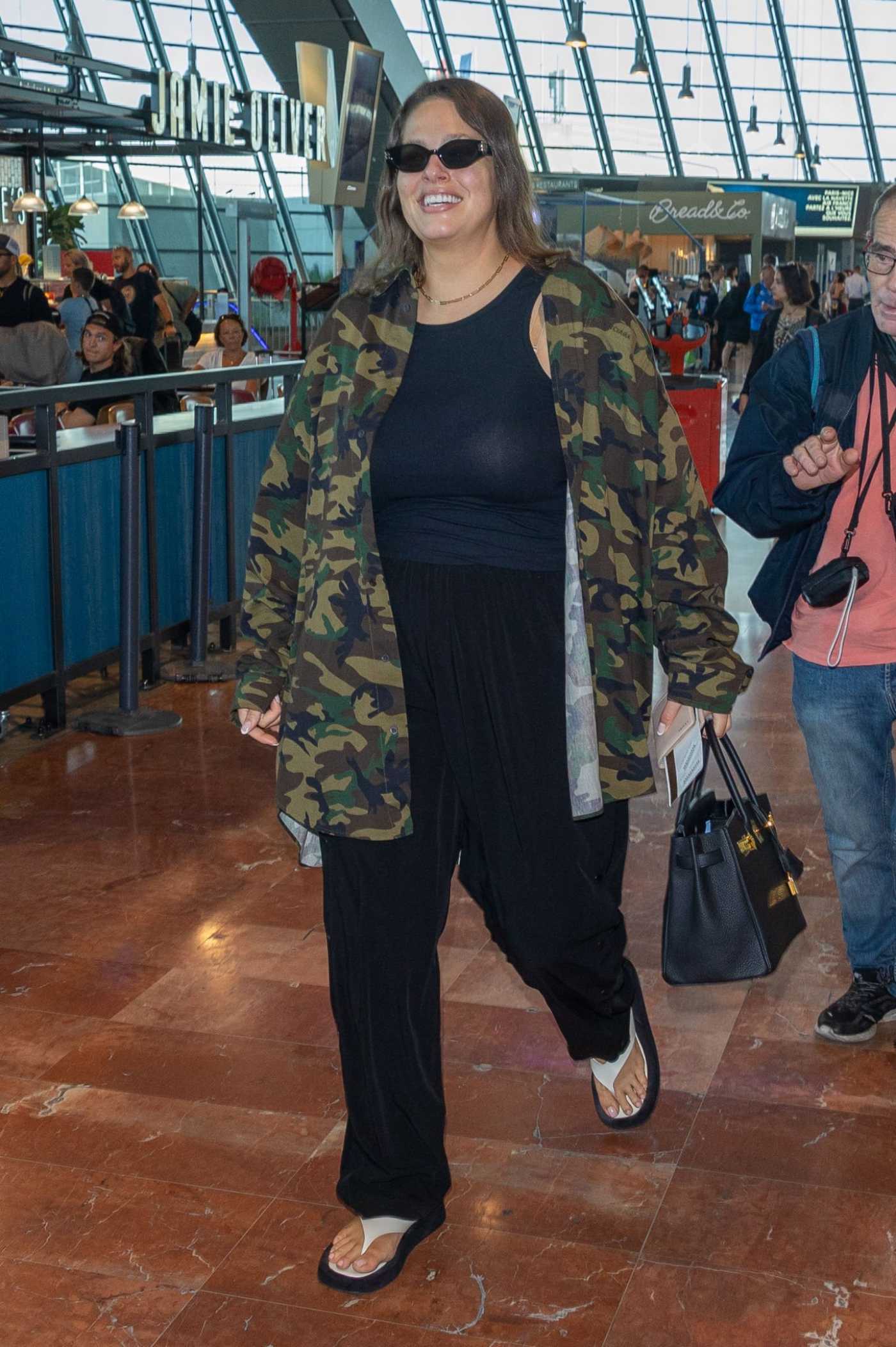 Ashley Graham in a Camo Shirt Arrives Ahead of Departing the 75th Annual Cannes Film Festival at Nice Airport in Nice 05/27/2022