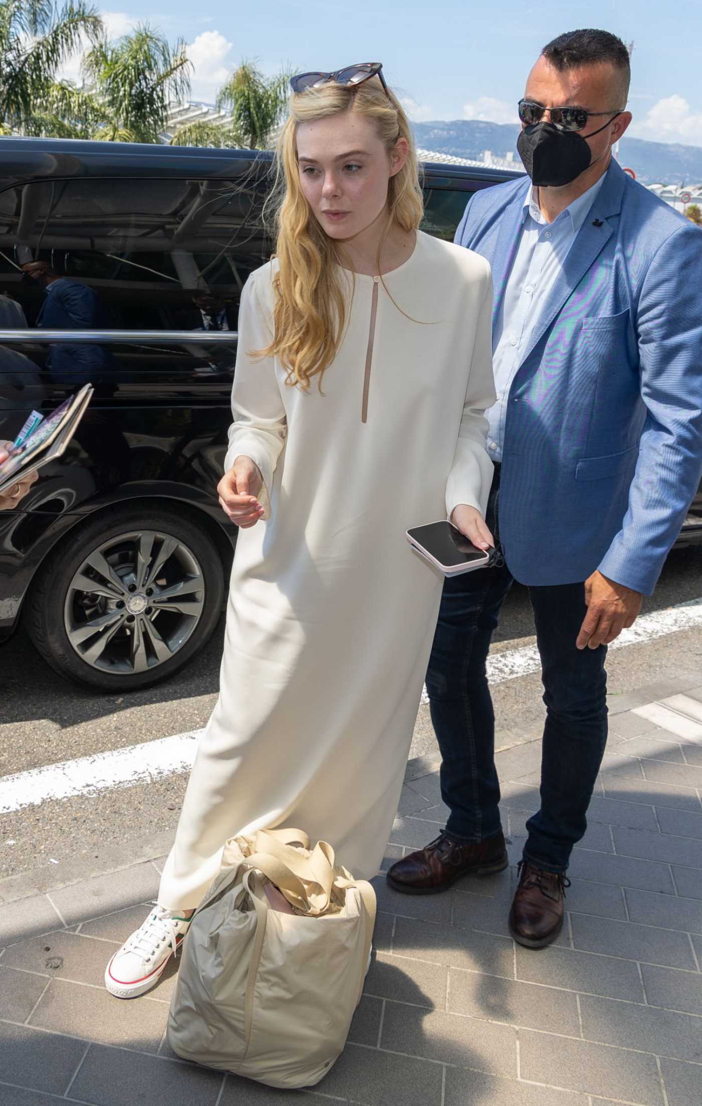 Elle Fanning in a Beige Dress Arrives at Nice Airport in Nice 05/19/2022