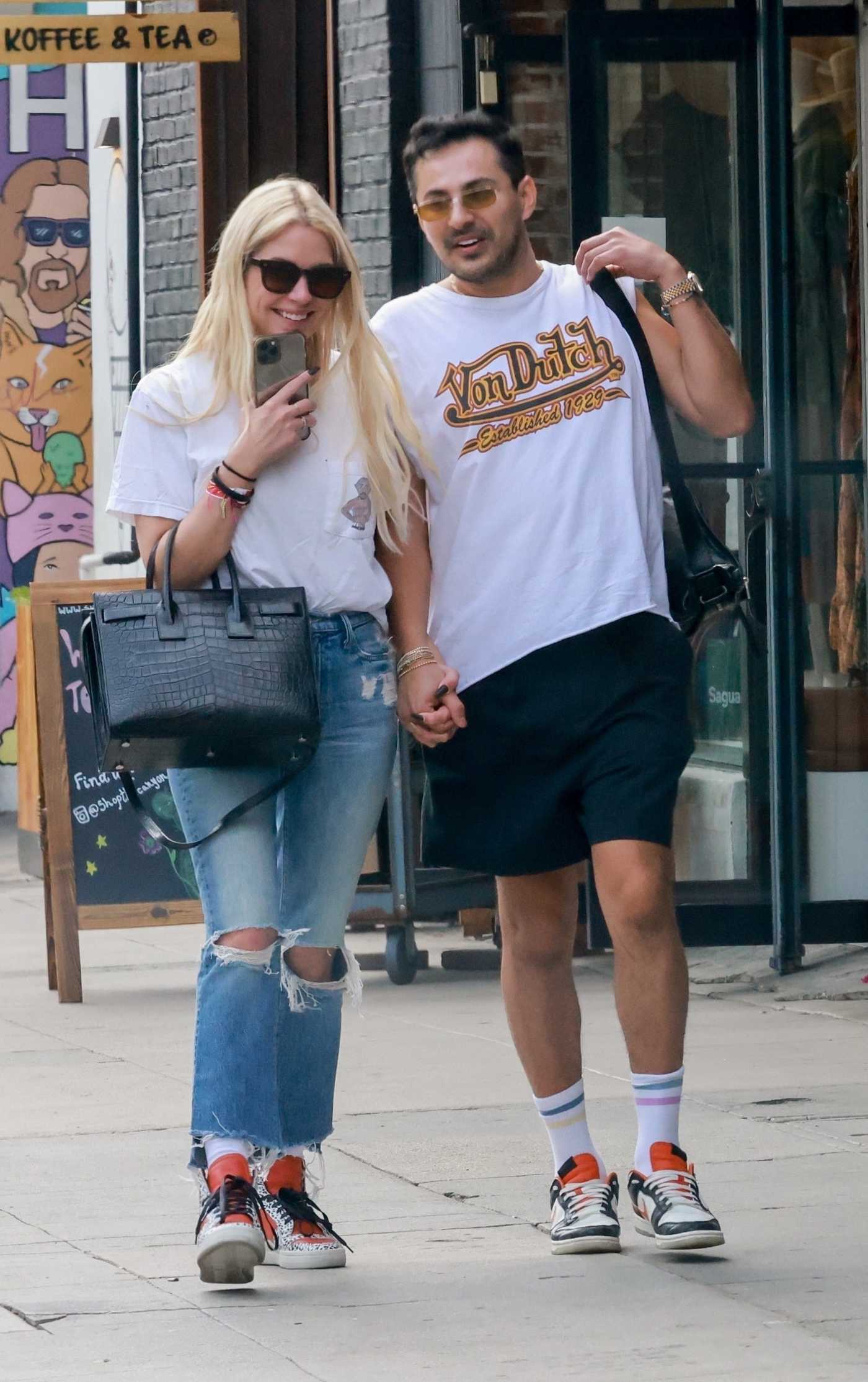 Ashley Benson in a Blue Ripped Jeans Walks Hand in Hand with a Mystery Man After Meeting for Lunch in Los Feliz 06/04/2022
