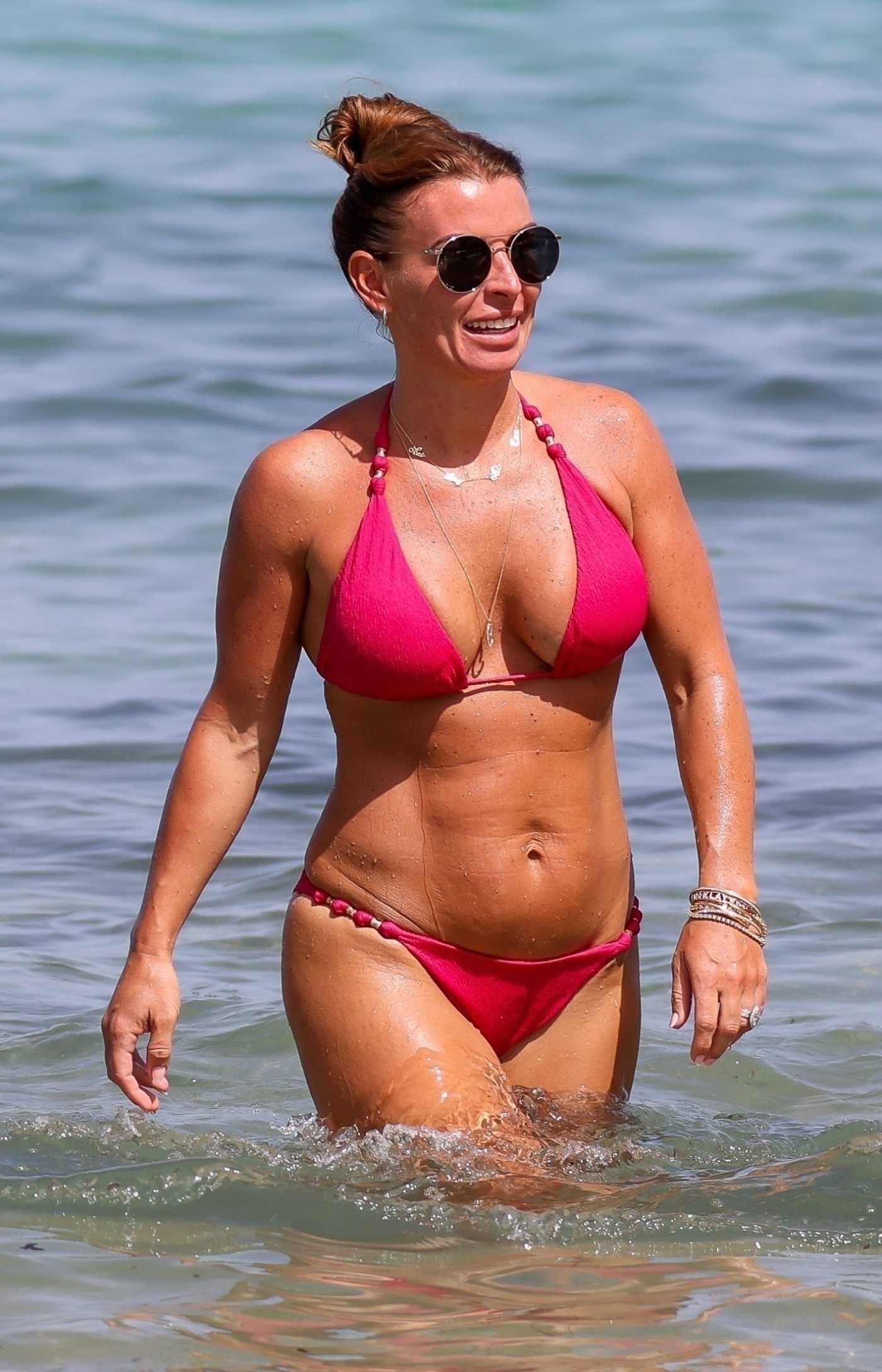 Coleen Rooney in a Pink Bikini on the Beach in Ibiza 06/17/2022
