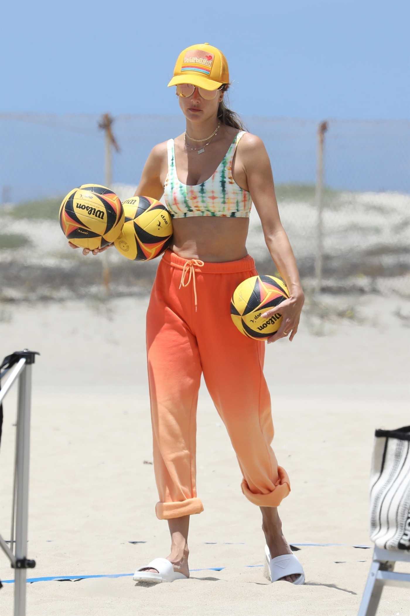 Alessandra Ambrosio in an Orange Sweatpants Attends a Beach Volleyball Practice on the Beach in Santa Monica 07/14/2022