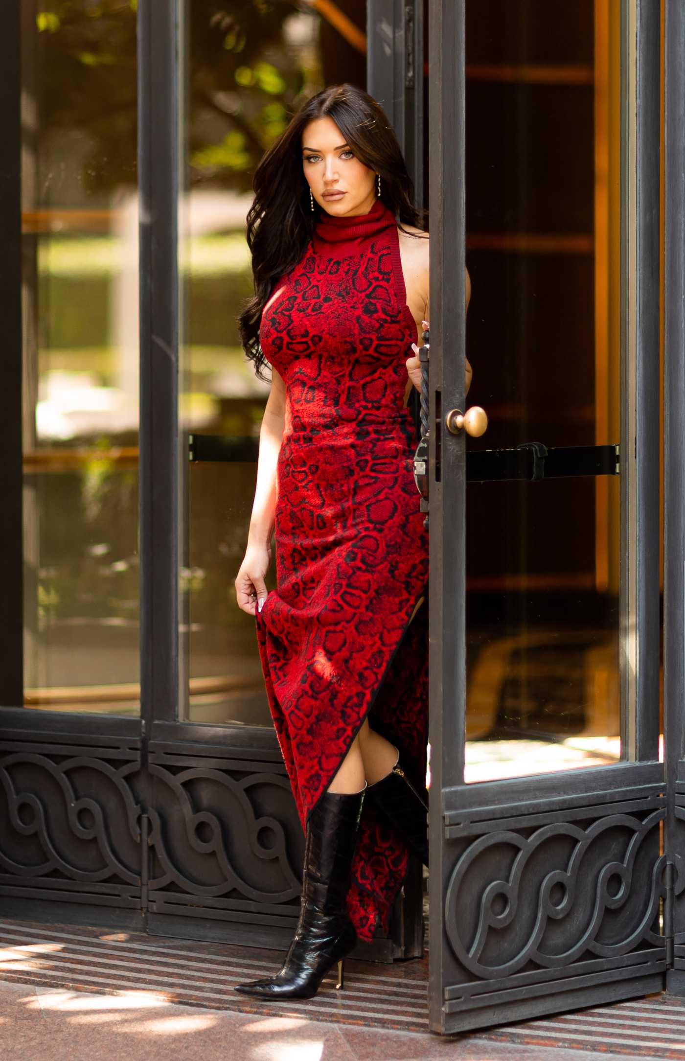 Anastasia Karanikolaou in a Red Snakeskin Print Dress Leaves the Principe Di Savoia Hotel in Milan 09/22/2022