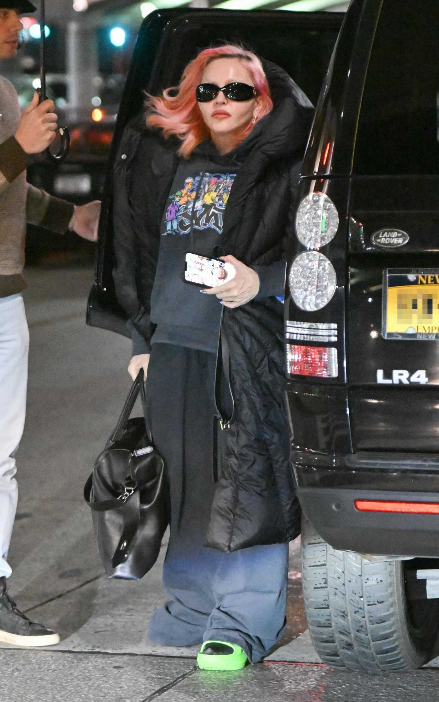 Madonna in a Black Puffer Coat Arrives at JFK Airport in New York 10/02/2022