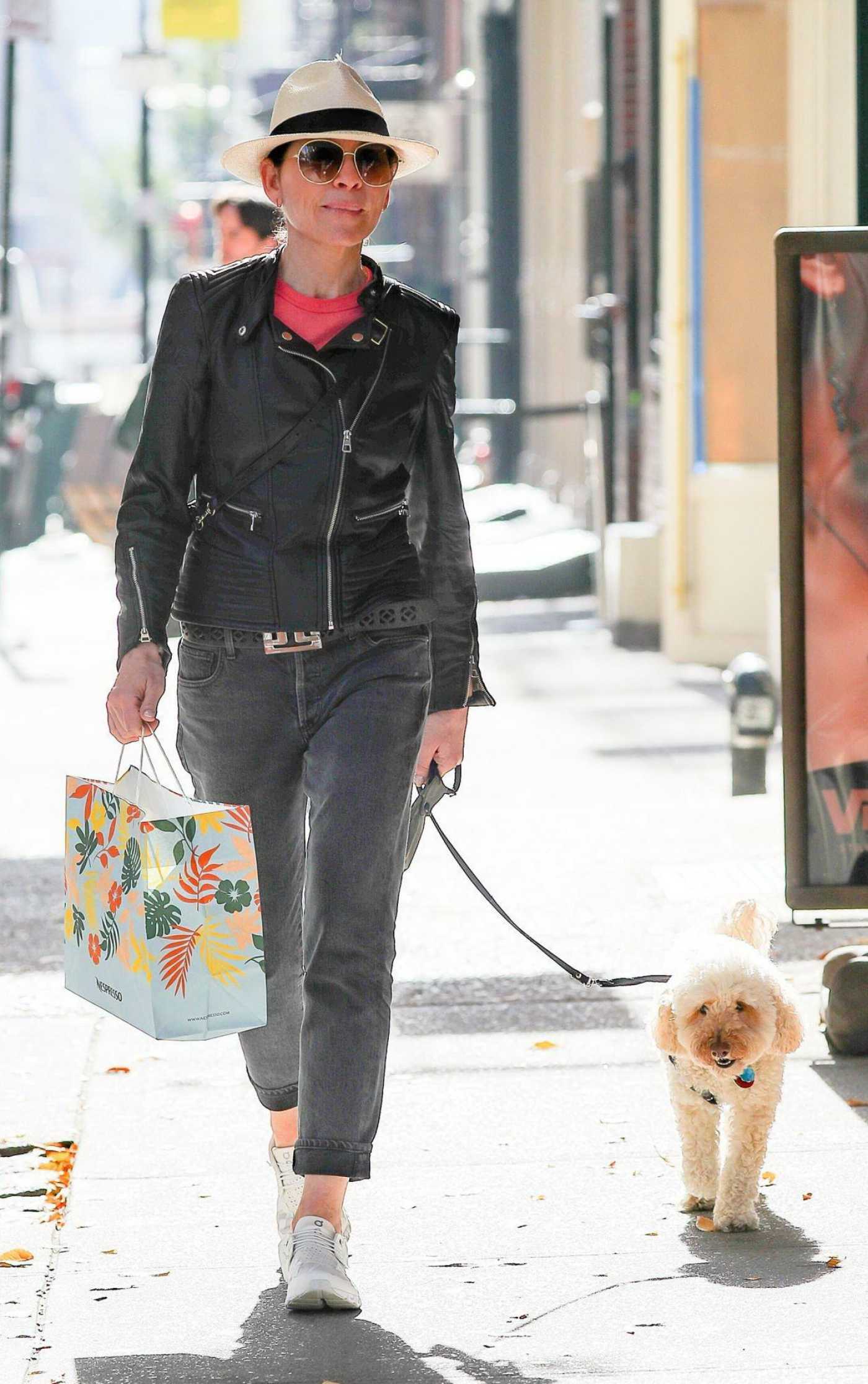 Julianna Margulies in a Black Leather Jacket Walks Her Dog in New York City 11/04/2022