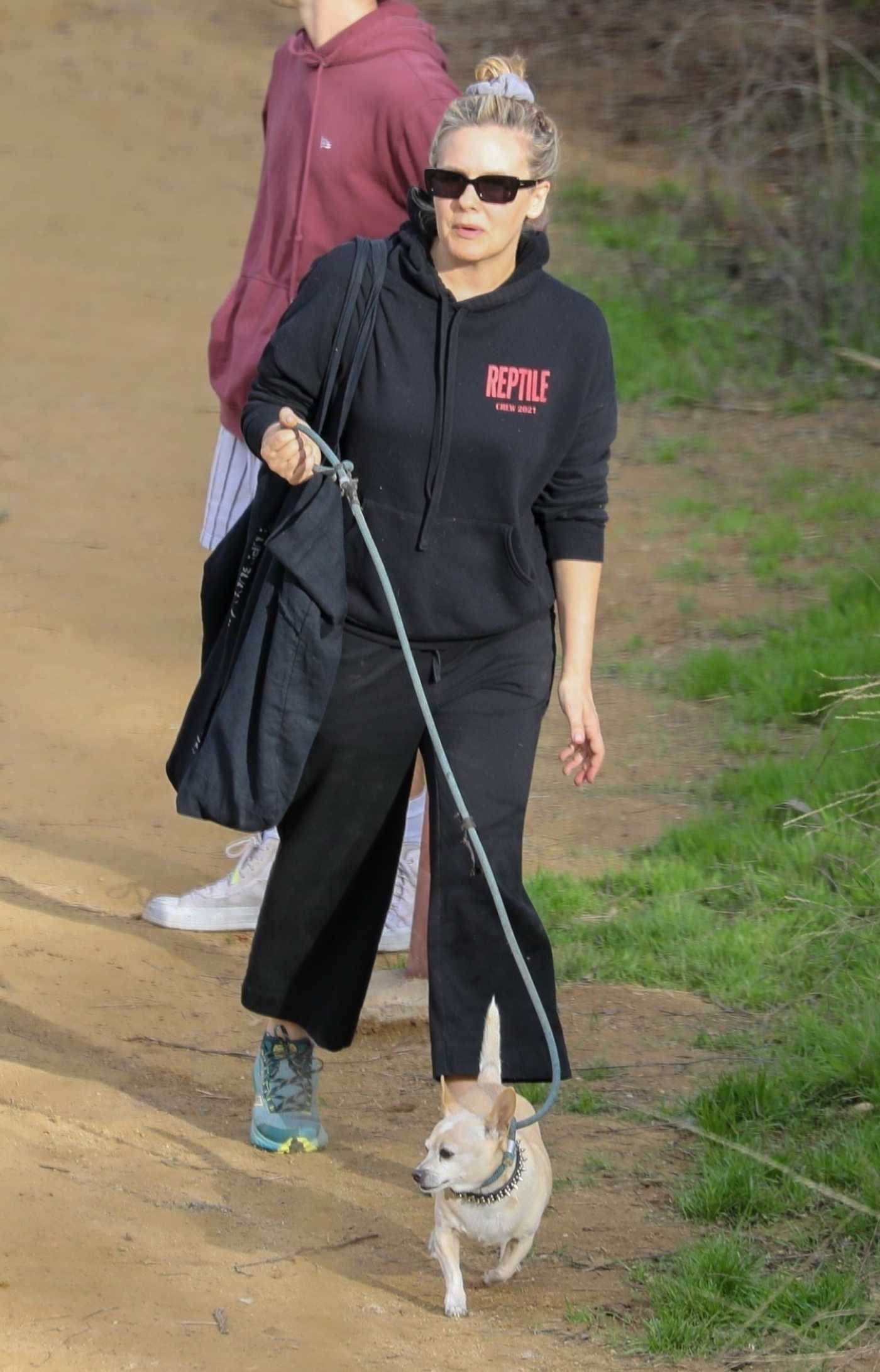 Alicia Silverstone in a Black Hoodie Walks Her Dog in Los Angeles 12/22/2022