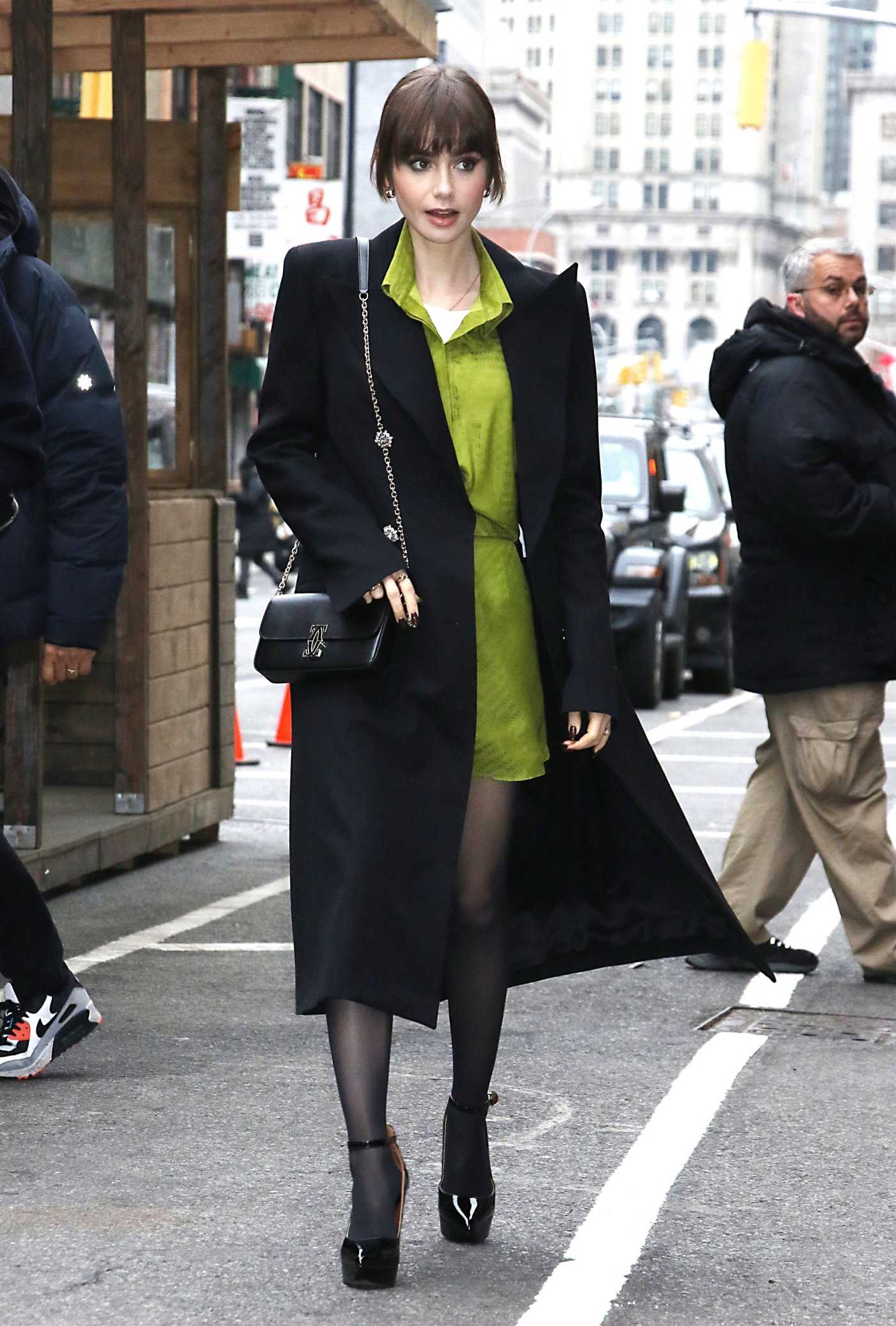 Lily Collins in a Black Coat Attends the Emily in Paris Pop-Up Event in New York 12/15/2022