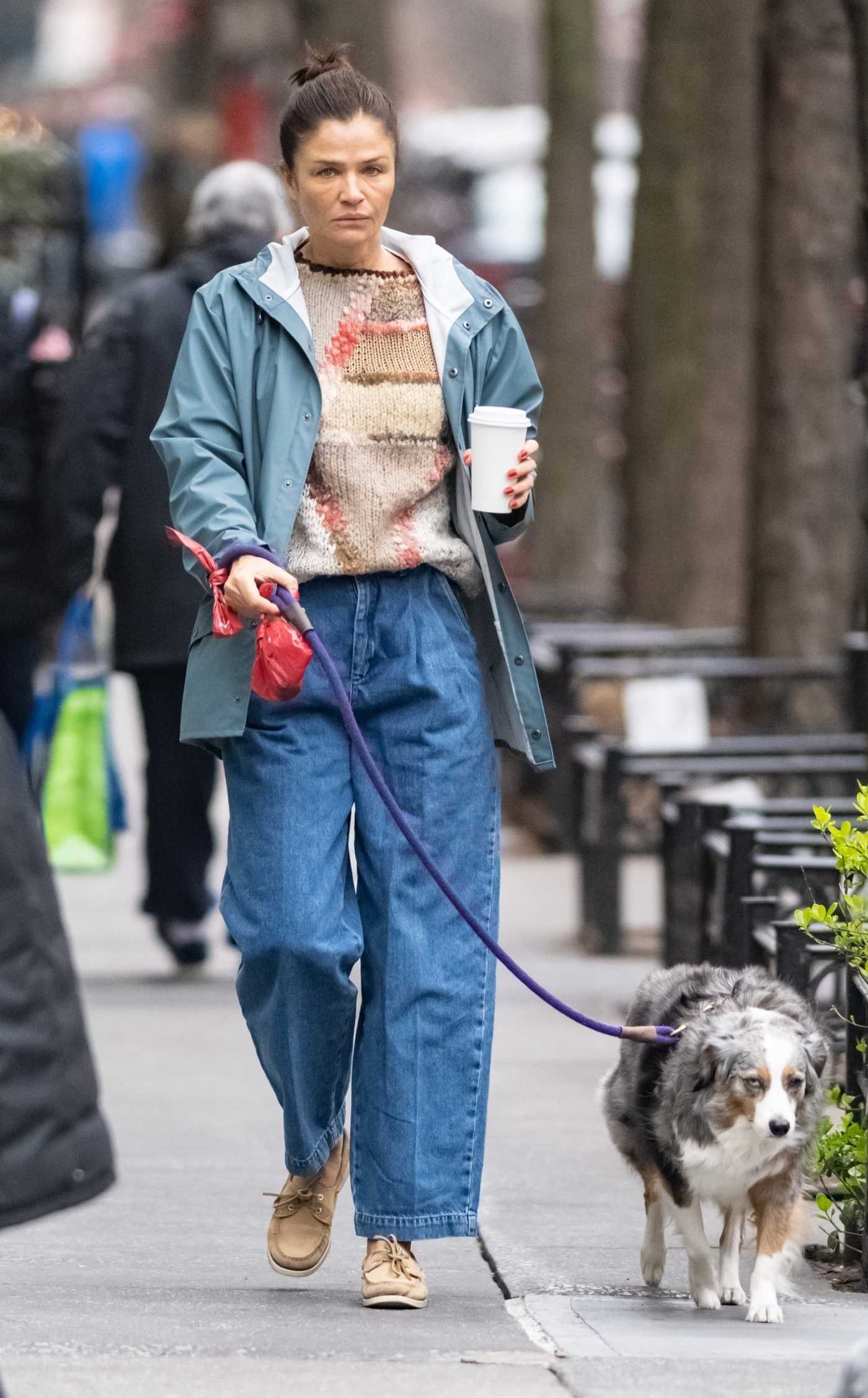 Helena Christensen in a Blue Windbreaker Walks Her Dog in New York 03/24/2023
