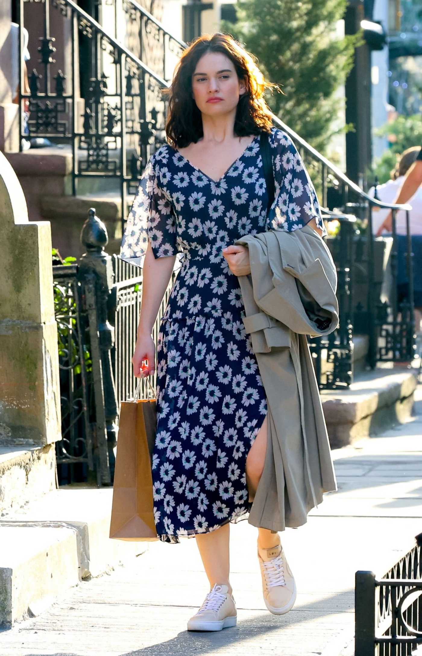 Lily James in a Blue Floral Dress on the Set of Relay in New York 04/12/2023