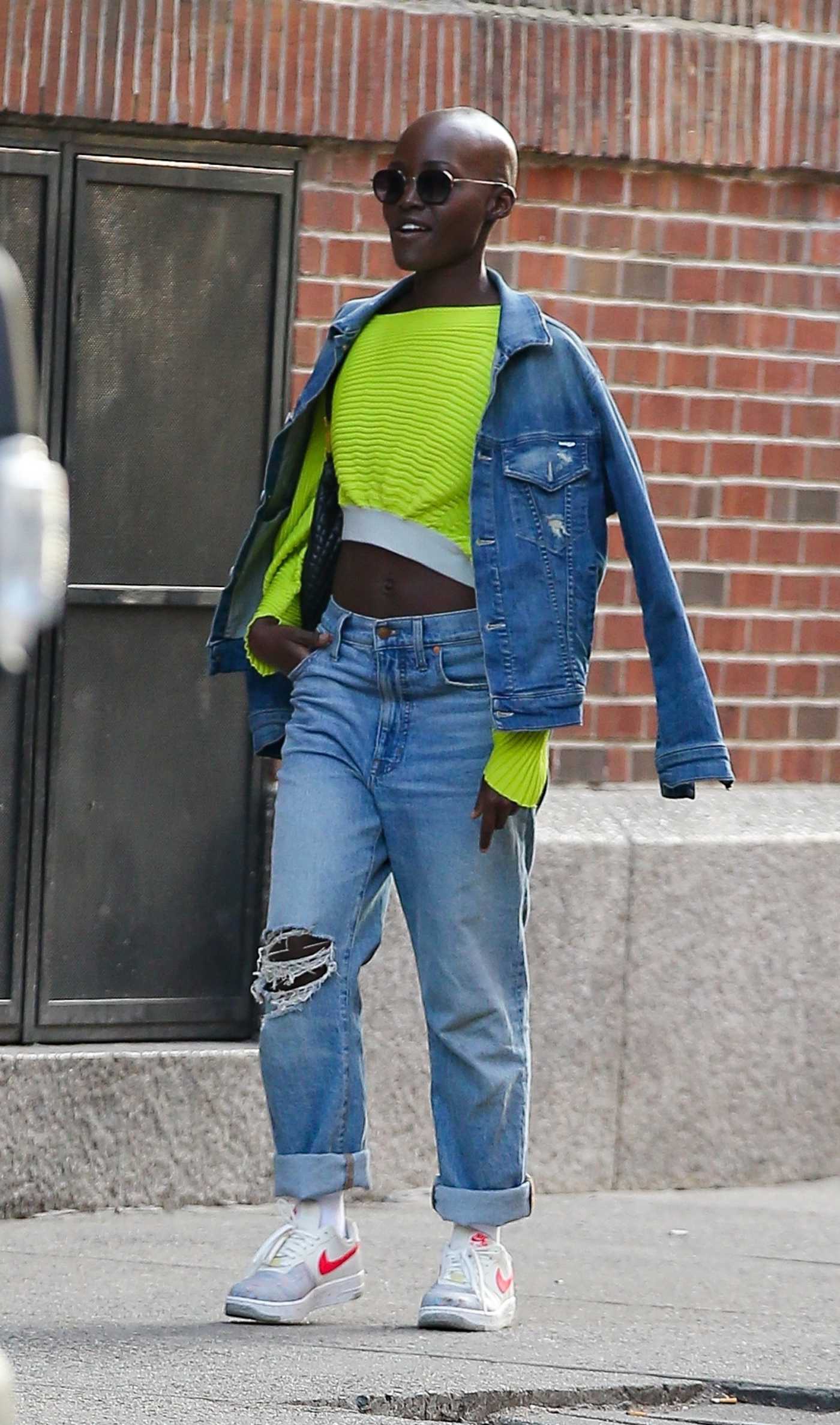 Lupita Nyongo in a Blue Denim Ensemble Steps Out for a Stroll with a Friend in New York 05/10/2023