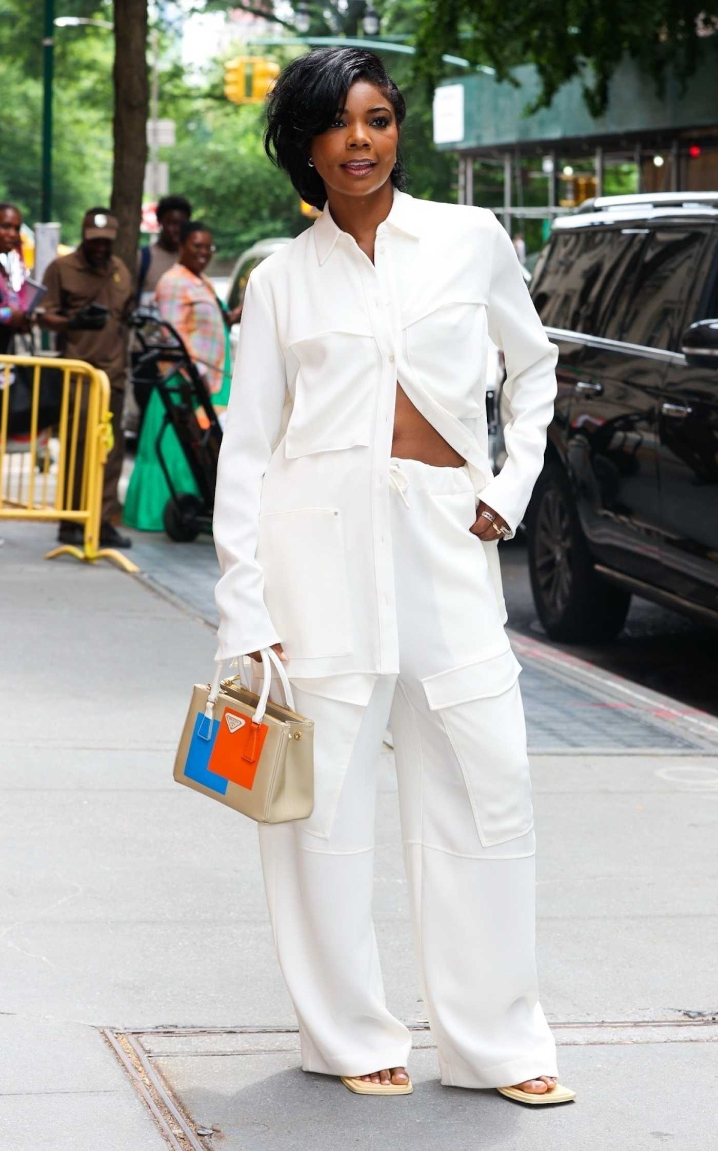 Gabrielle Union in a White Pantsuit Stops for Cameras Outside ABC in New York 06/14/2023
