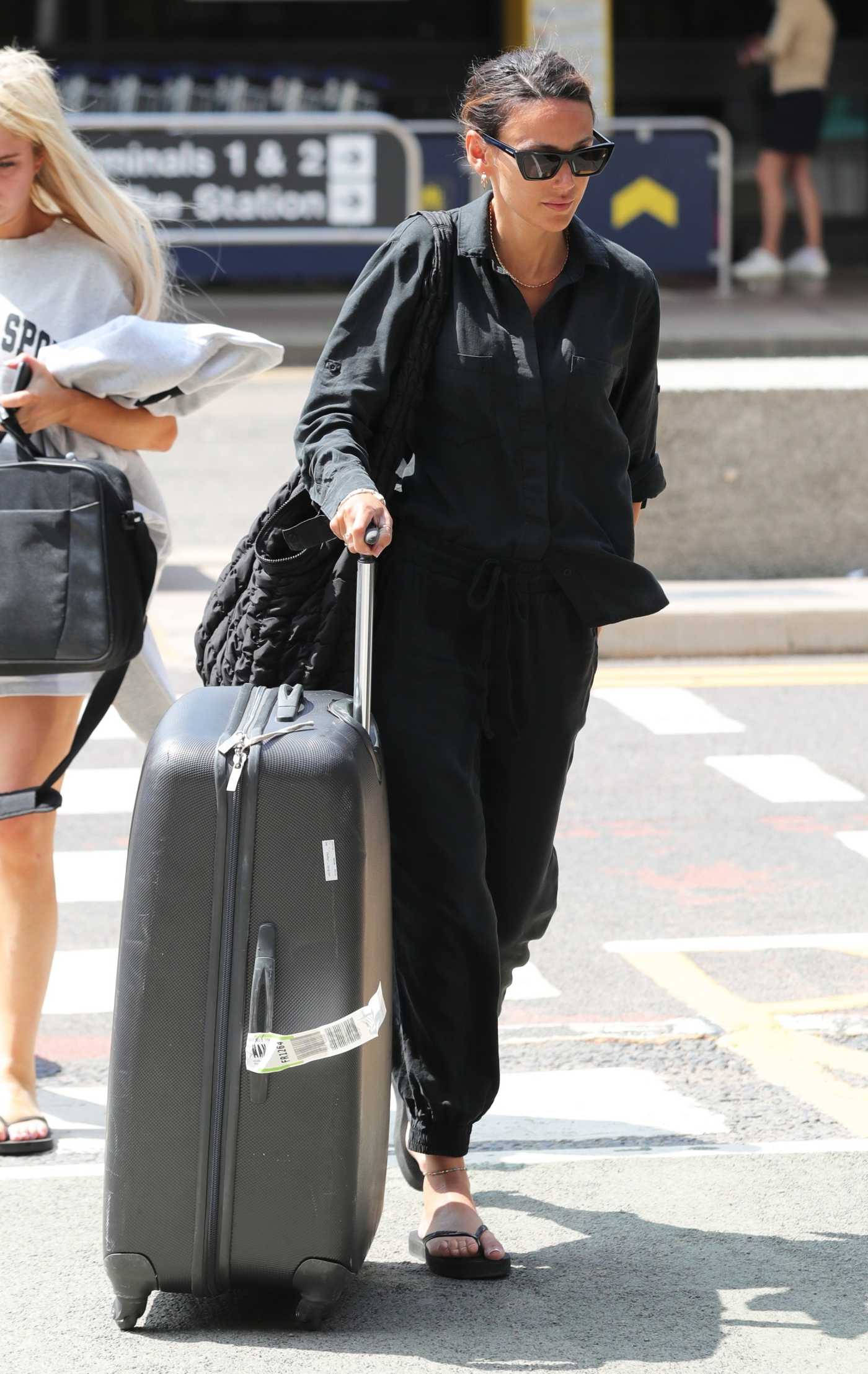 Michelle Keegan in a Black Shirt Arrives at Airport in Manchester 06/24/2023