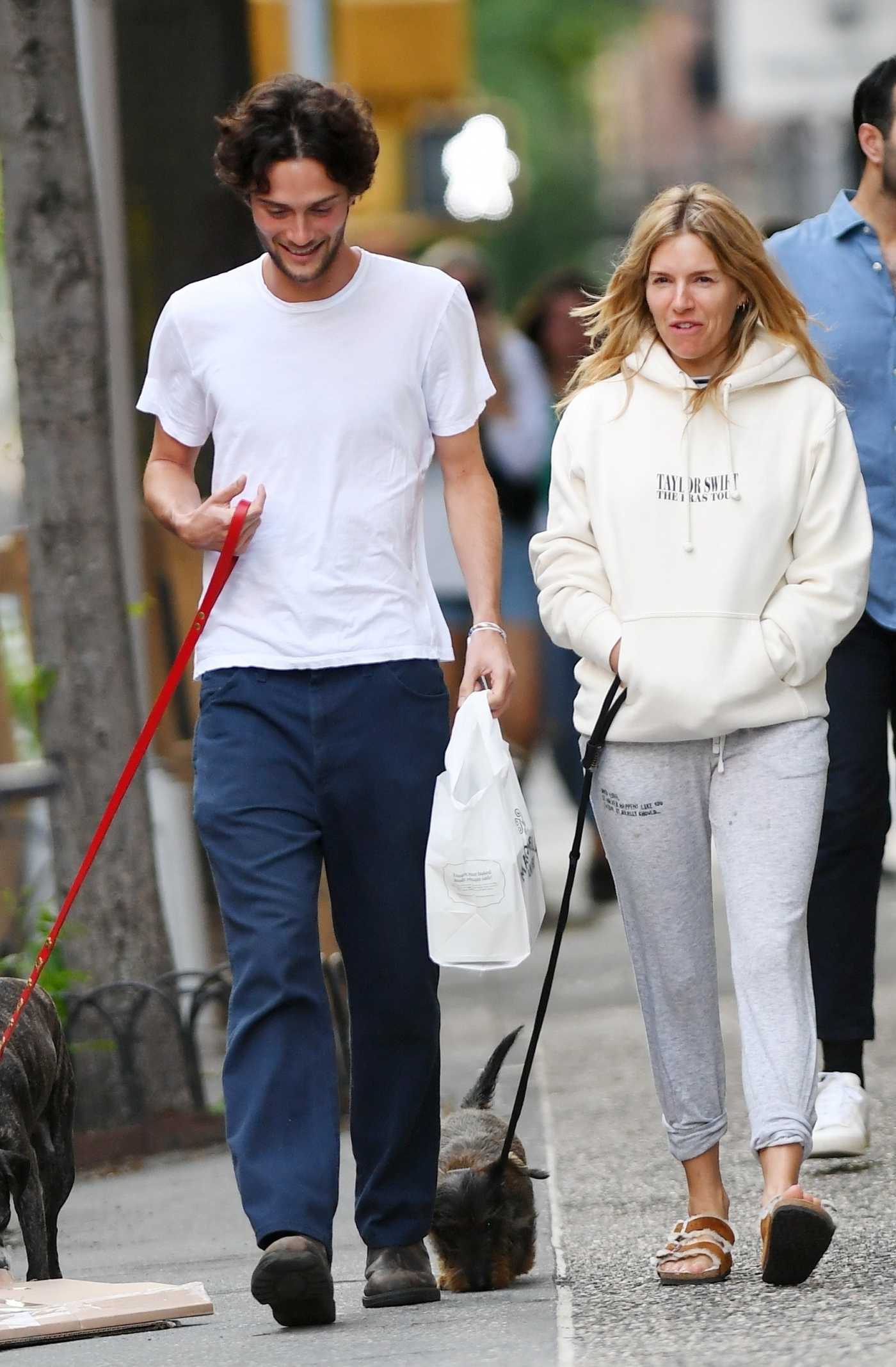 Sienna Miller in a White Hoodie Walks Her Dogs with Oli Green in New York 05/30/2023