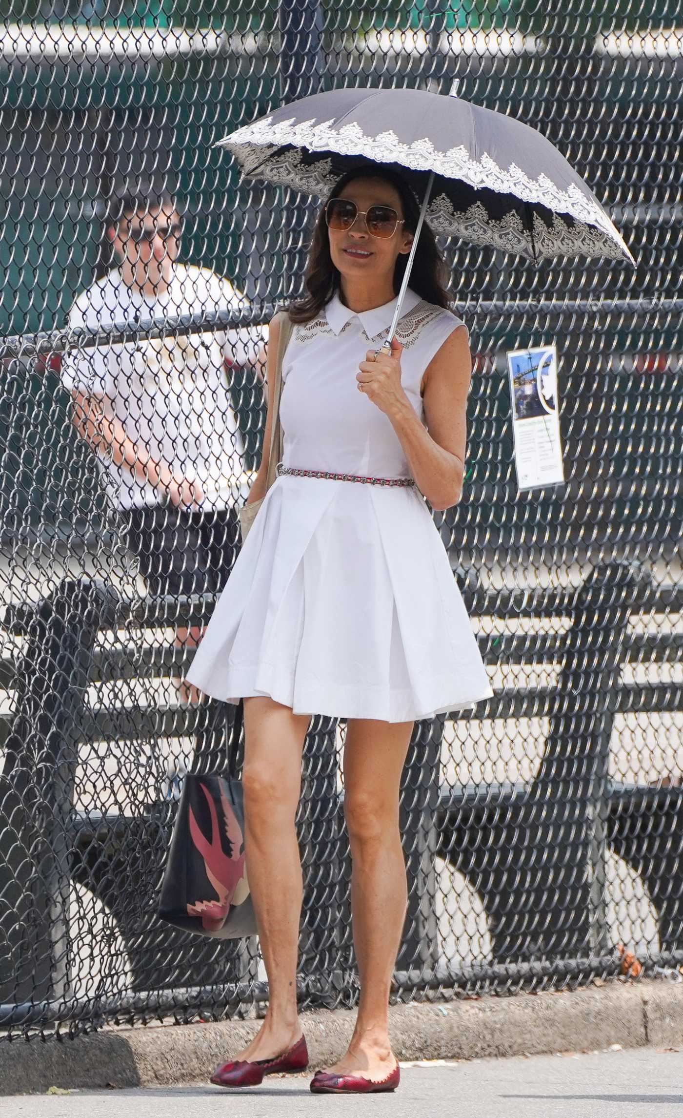 Famke Janssen in a White Dress Was Spotted Out with a Male Friend in Downtown Manhattan in NYC 06/29/2023