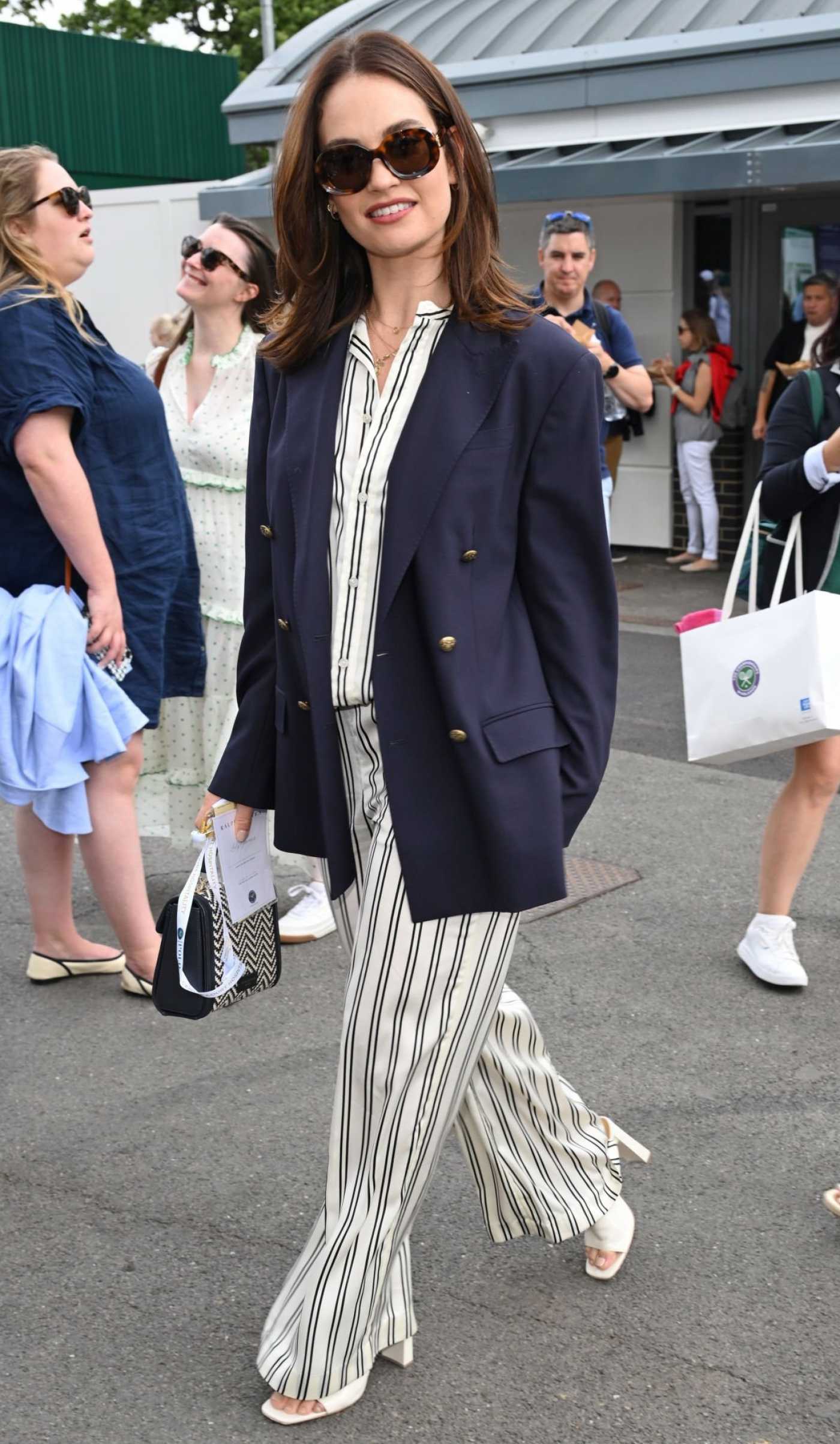Lily James in a Striped Pants Arrives at the Men's Final Match at 2023 Wimbledon Tennis Championship in London 07/16/2023