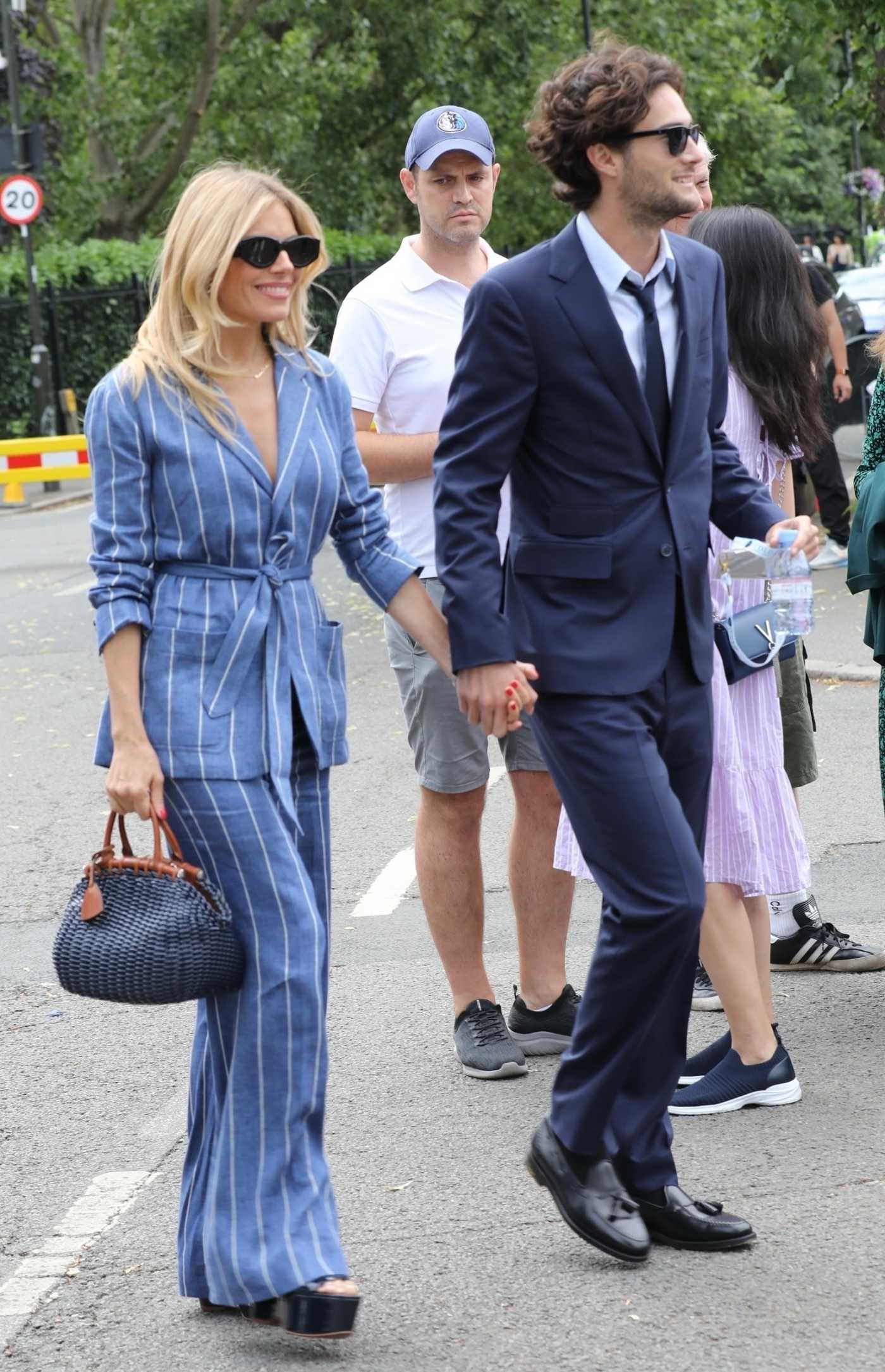 Sienna Miller in a Blue Striped Pantsuit Arrives at the All England Lawn Tennis and Croquet Club with Oli Green in London 07/09/2023
