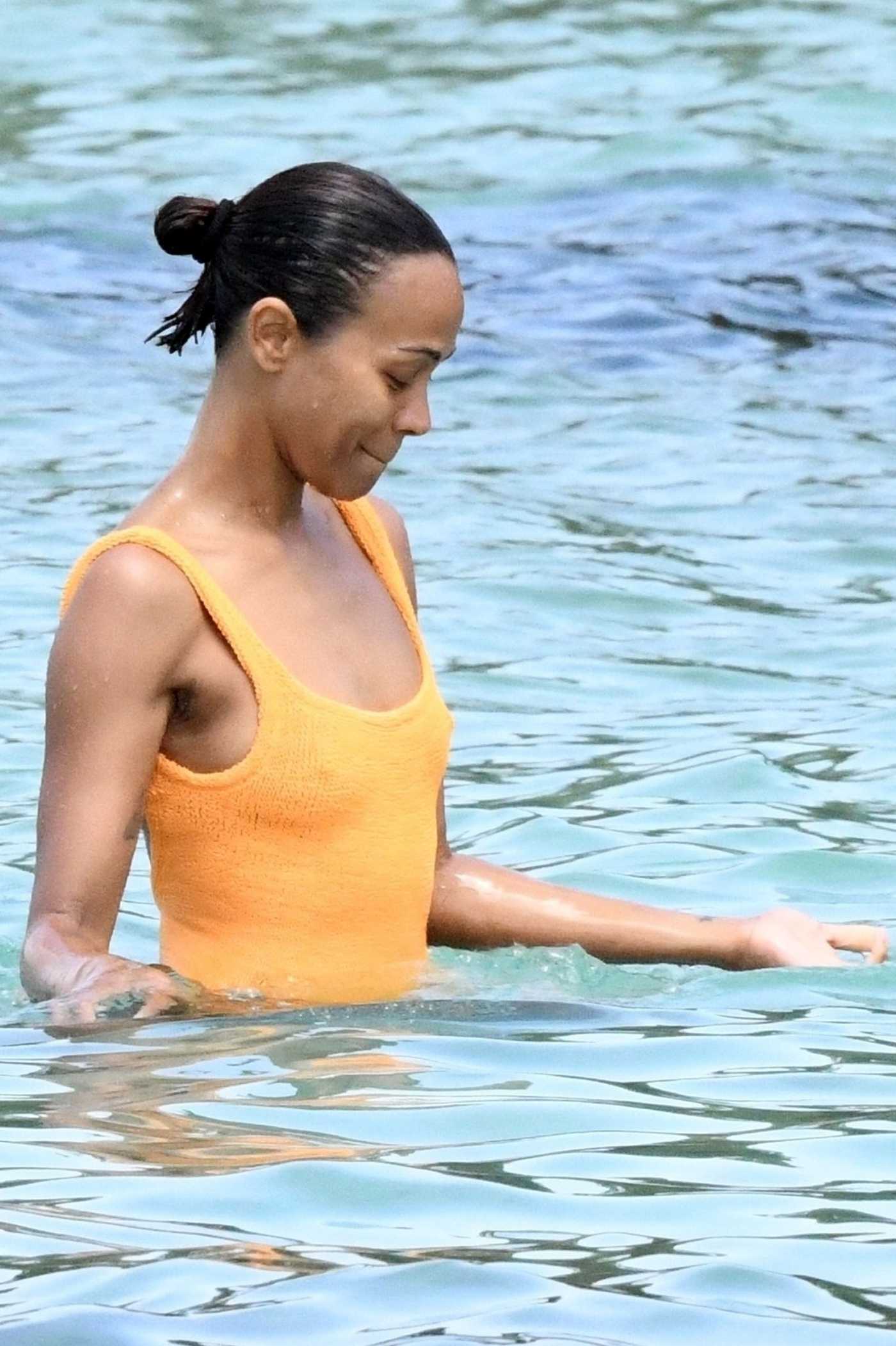 Zoe Saldana in an Orange Swimsuit on the Beach in Sardinia 07/23/2023