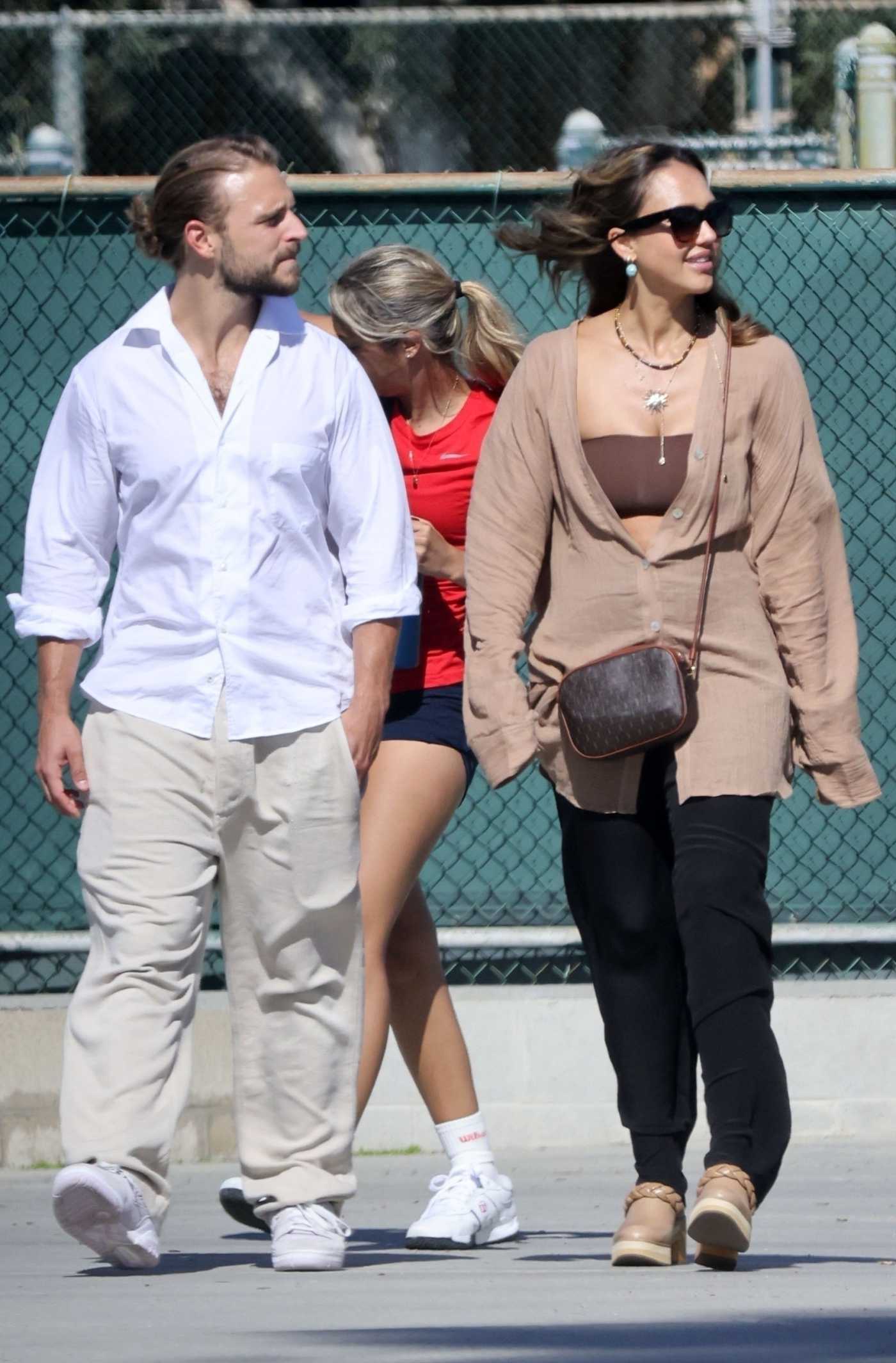 Jessica Alba in a Tan Shirt Was Spotted Out for a Tennis Match with Brandon Green in Los Angeles 08/25/2023