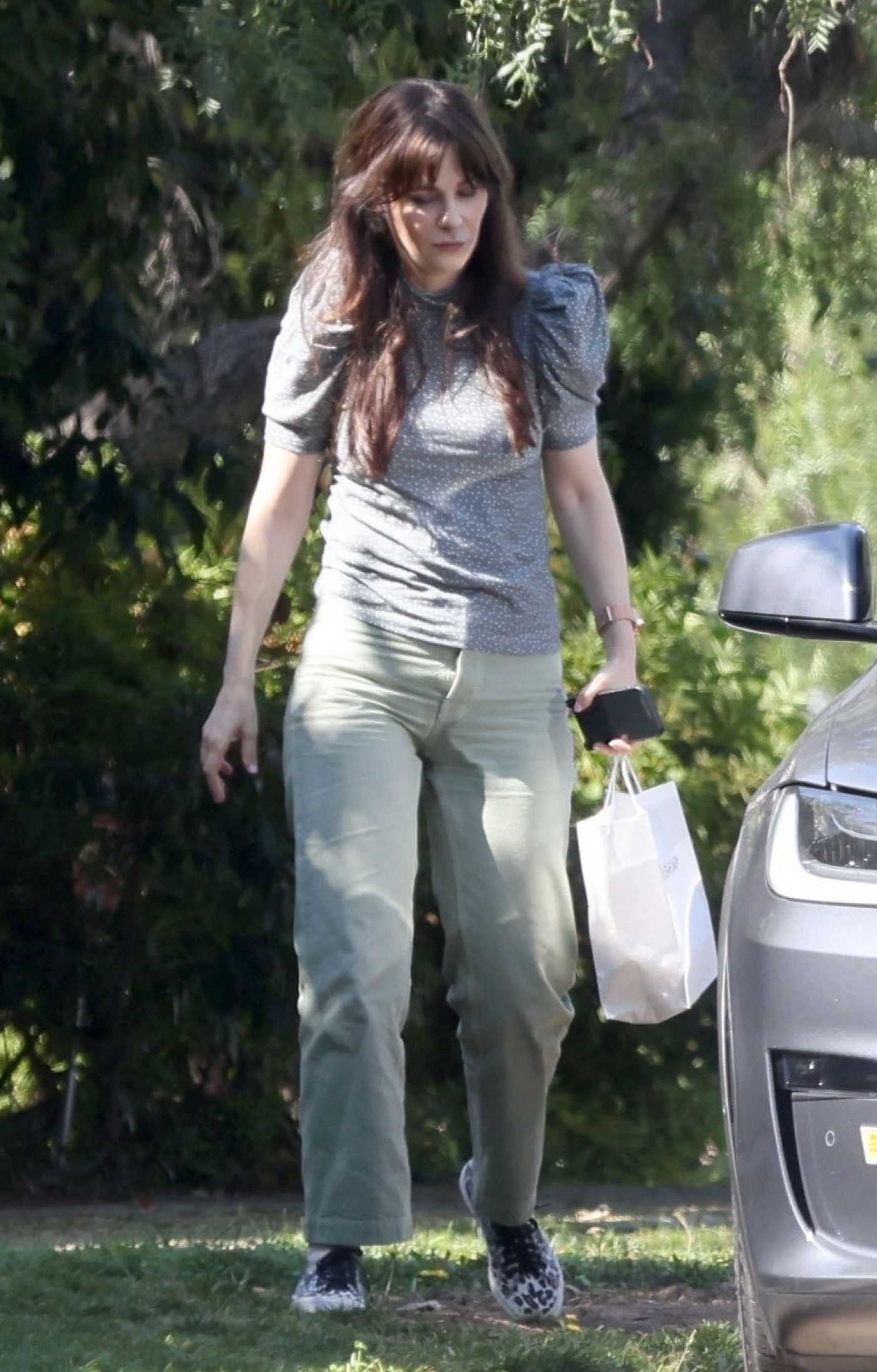 Zooey Deschanel in a Grey Polka Dot Blouse Leaves a Friend's House in Los Angeles 08/29/2023