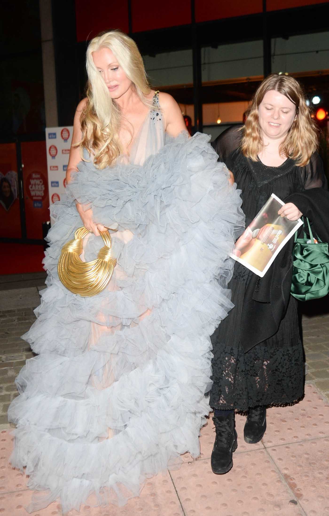 Caprice Bourret in a Grey Dress Leaves The Sun's Who Cares Wins Awards at The Roundhouse in London 09/19/2023